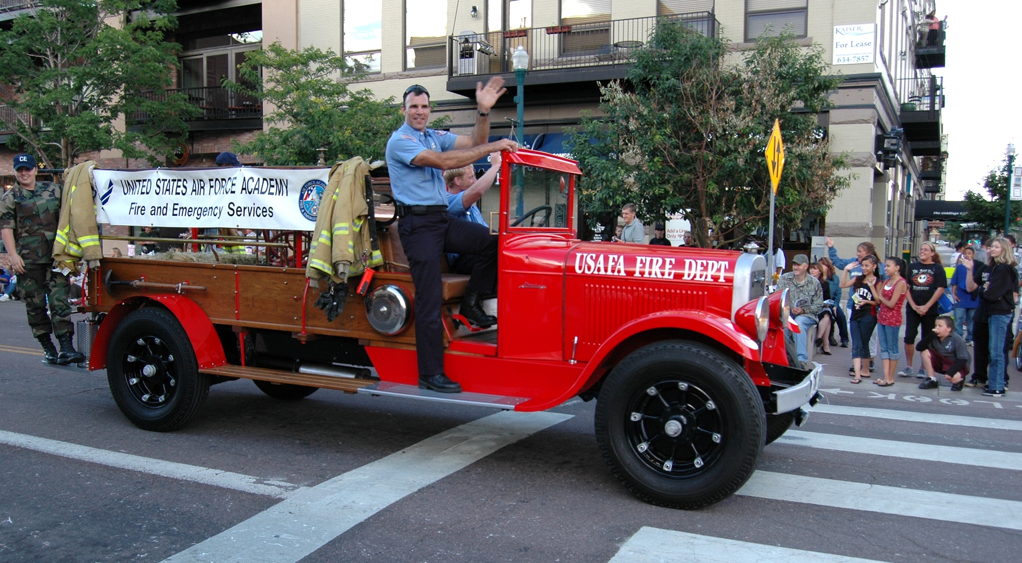 Firemen from the U.S. Air Force Academy showed off their vintage fire truck as part of the Pikes Peak or Bust Rodeo parade July 8 in downtown Colorado Springs, Colo. The Rodeo runs through July 12 at the Norris-Penrose Events Center. A matinee is scheduled for 12:30 p.m. and a performance at 7 p.m. July 12 as part of the Air Force Space Command night. (U.S. Air Force photo/Steve Brady)
