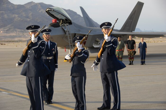 Members of the Nellis Air Force Base Honor Guard firing party signal the start of the 57th Wing's third-quarter load crew competition July 11, 2008. The competition is used to measure load teams' ability to acurately and efficiently load weapons on today's premier aircraft. (U.S. Air Force photo by Staff Sgt. Kenny Kennemer)