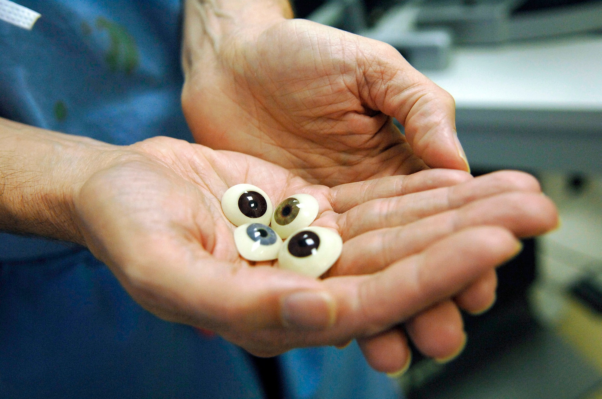 Col. (Dr.) Randall Beatty holds various prosthesis that are like large hard contact lenses that fit over the entire eye socket and give the patient a renewed send of self. Doctor Beatty is a 332nd Expeditionary Medical Operations Squadron ophthalmologist and orbital oculoplastics specialist. (U.S. Air Force photo/Senior Airman Julianne Showalter)