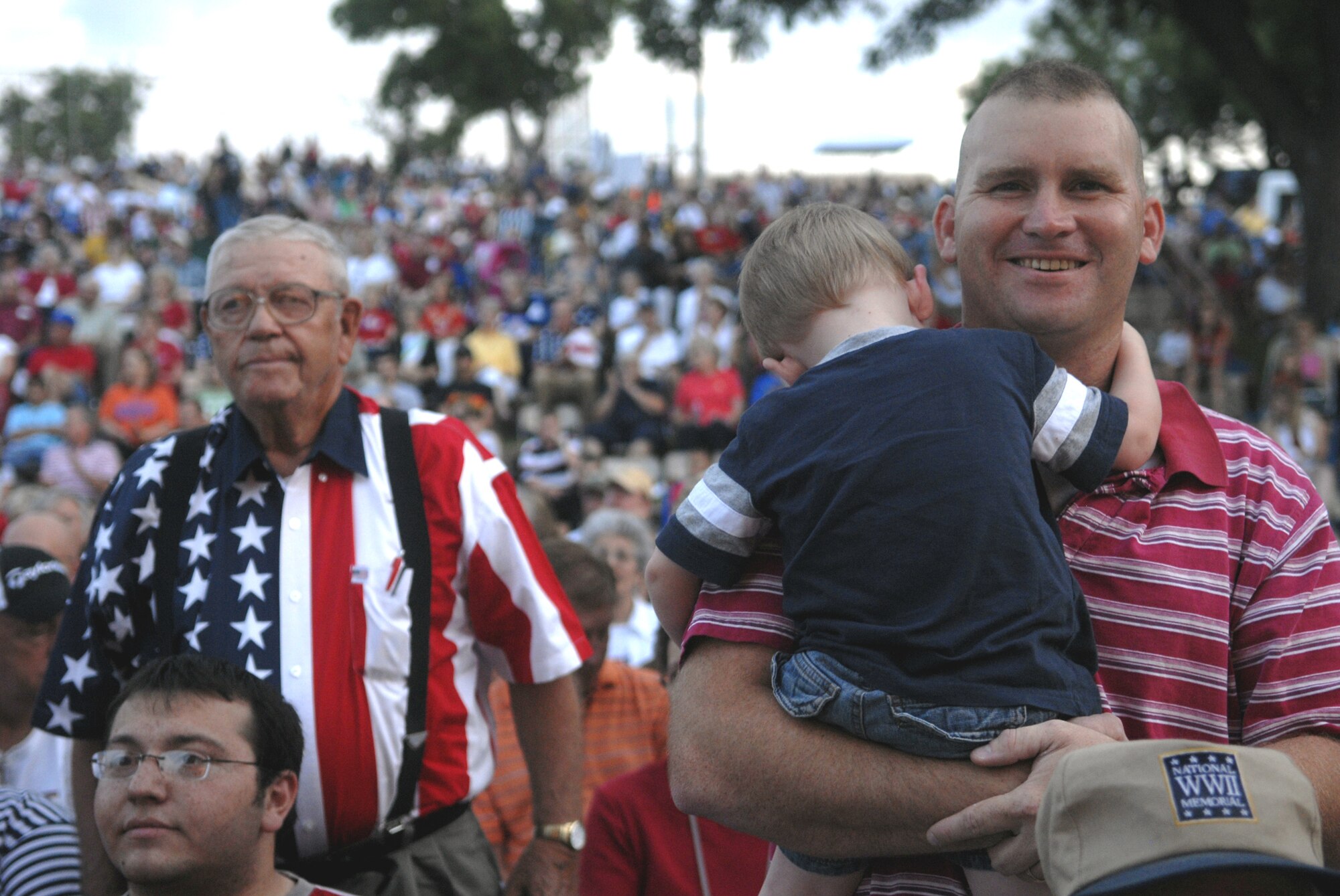 During the playing of the Marine Corps song, Marine Corps detachment commander Capt. Henry Billings stands and proudly represents the Marine Corps along with other veteran Marines. (U.S. Air Force photo by Senior Airman Kamaile Chan)
