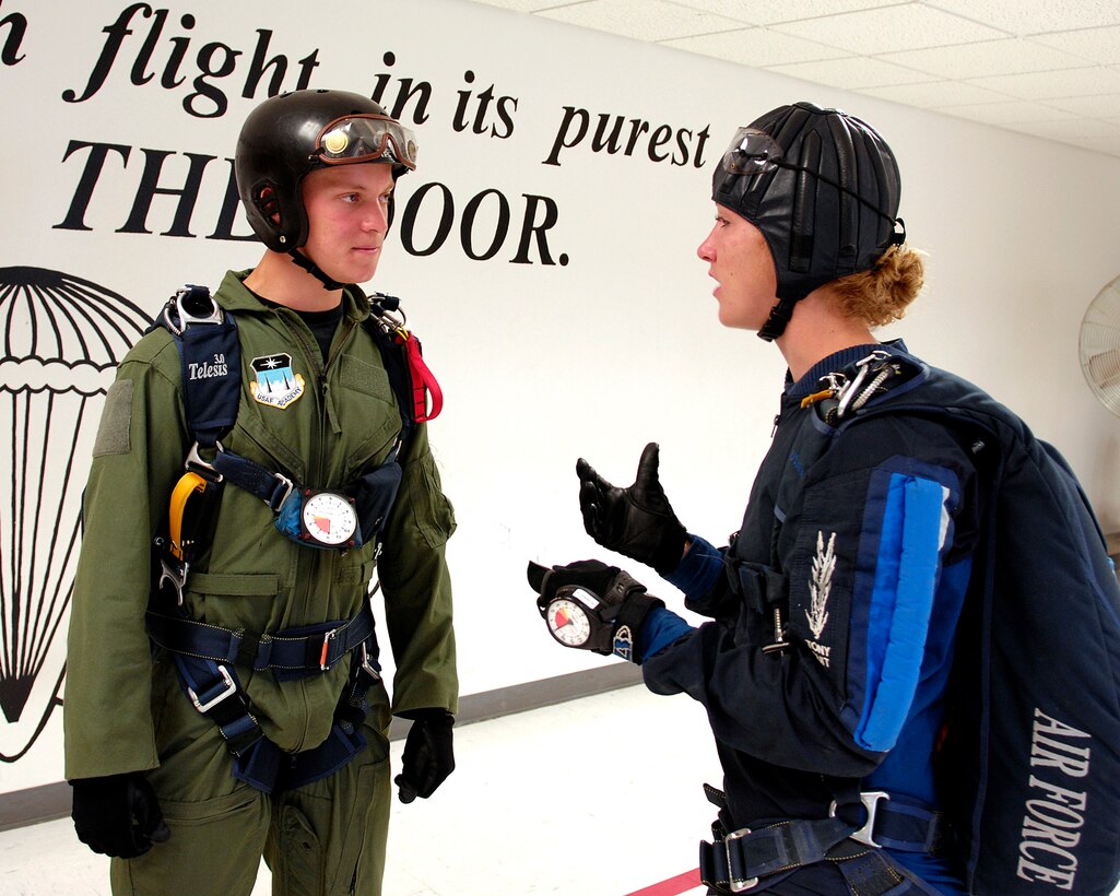 U.S. Air Force Academy Cadet 3rd Class David Barron is briefed by jumpmaster Cadet 1st Class Lindsey Robinson July 7 during Airmanship 490, Basic Parachuting, an airmanship program where cadets earn their basic jump wings after successfully completing five free-fall jumps. (U.S. Air Force photo/Mike Kaplan)