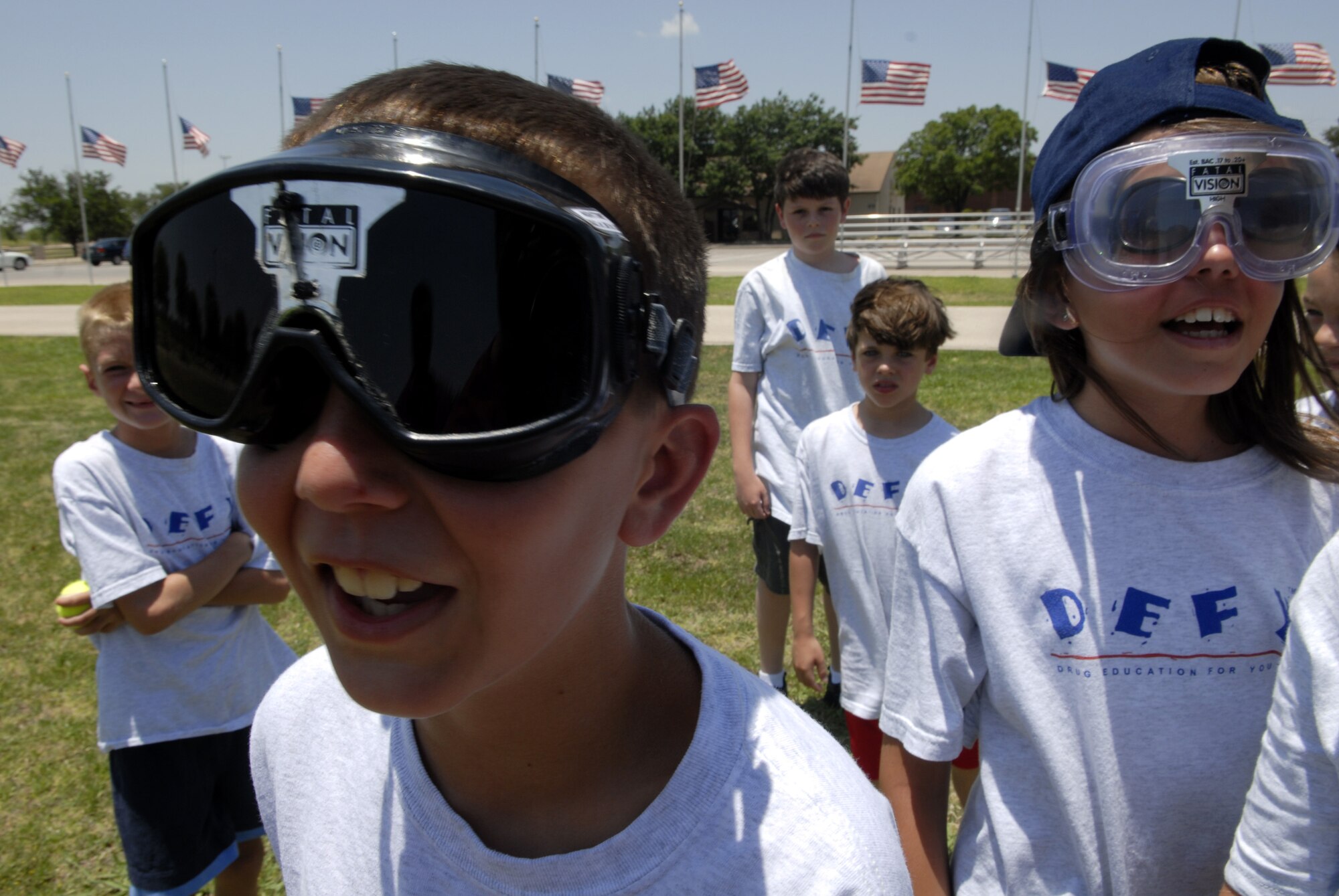Eleven-year-olds Lonnie Griffith and Bailey Nelson participate in wearing “drunken goggles” during an activity with the San Angelo police department at the base parade grounds. The youth were briefed on the dangers of driving under the influence and how to live a drug-free, alcohol-free lifestyle. (U.S. Air Force photo by Senior Airman Kamaile Chan)