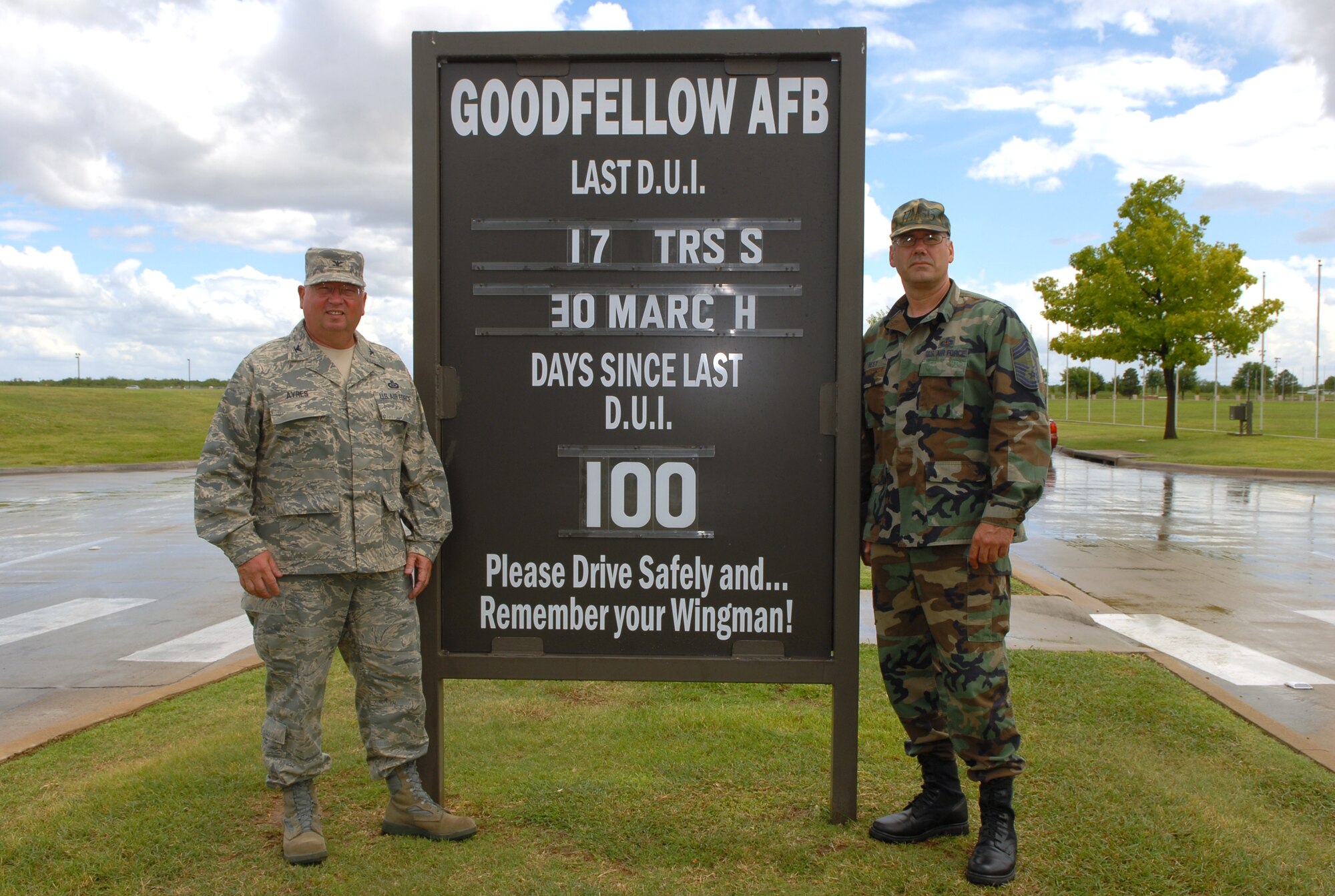 Colonel Richard Ayres, 17th Training Wing commander, and Chief Master Sgt. Leslie Best, 17th Mission Support Group superintendent, pose July 9 by the sign recognizing 100 days without a Driving Under the Influence of Alcohol violation on Goodfellow. (U.S. Air Force photo by Staff Sgt. John Barton)