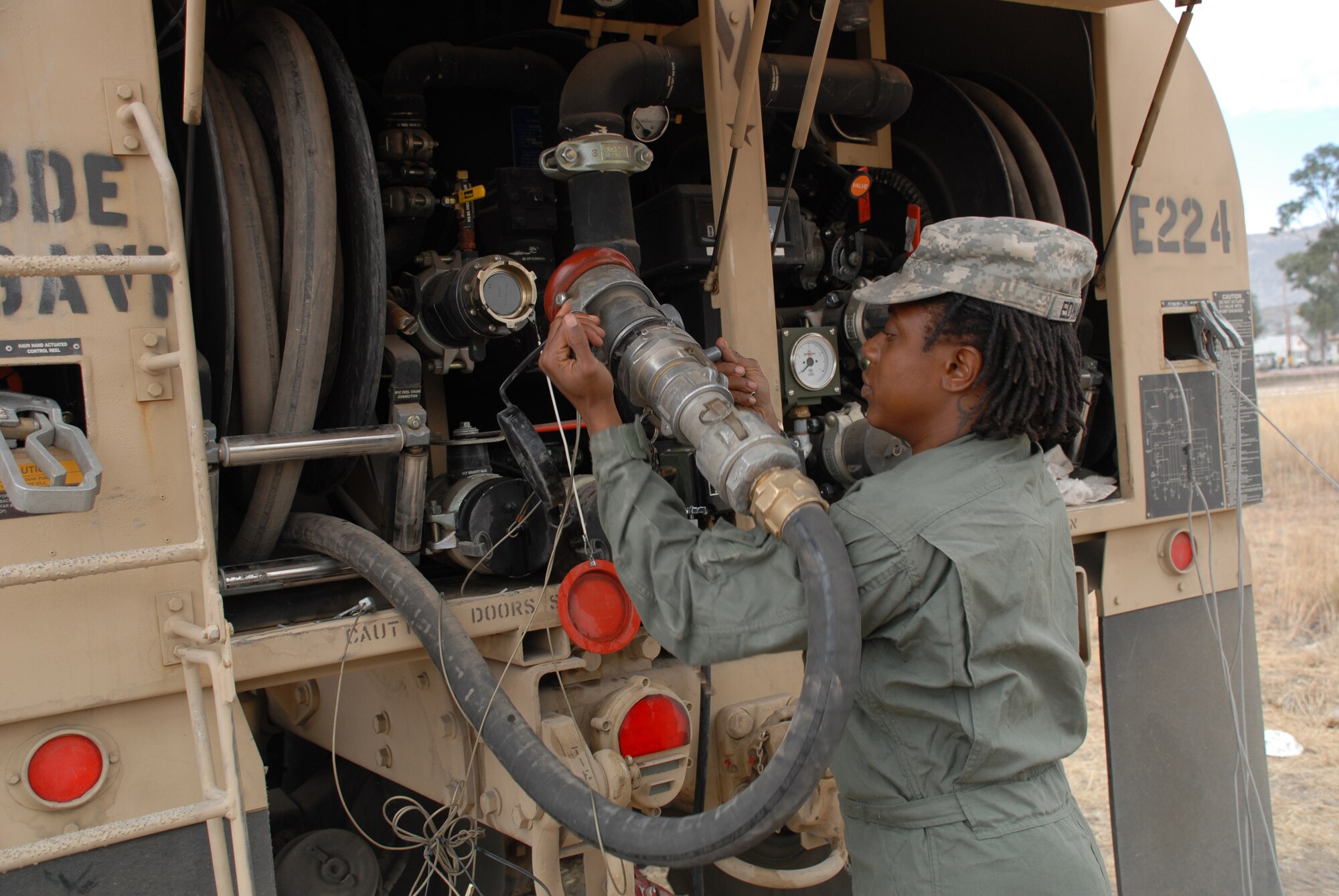 Spc. Linda Edwards, an aircraft refueler deployed from the 5th Battalion, 159 Aviation Regiment out of Fort Eustis, Va., removes a hose from a fuel truck used in support of New Horizons Peru-2008, June 11. (U.S. Air Force photo/Airman 1st Class Tracie Forte)