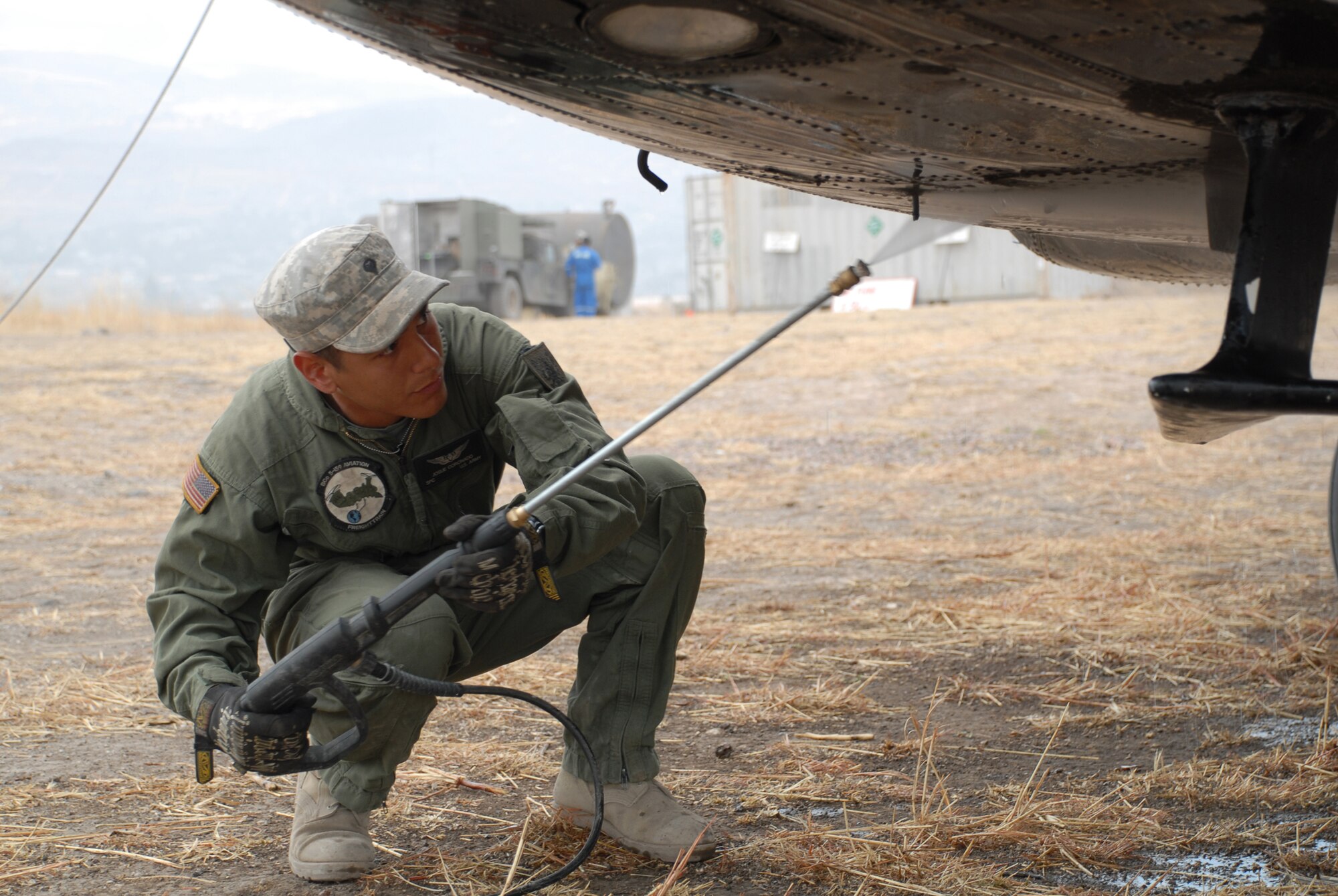 U.S. Army Spc. Josue Coronado-Iglesias, a crew chief from the 5th Battalion, 159 Aviation Regiment out of Fort Eustis, Va., power washes a CH-47 Chinook, currently residing in Los Cabitos, Peru and assigned to Task Force New Horizons Peru-2008, June 11. (U.S. Air Force photo/Airman 1st Class Tracie Forte)