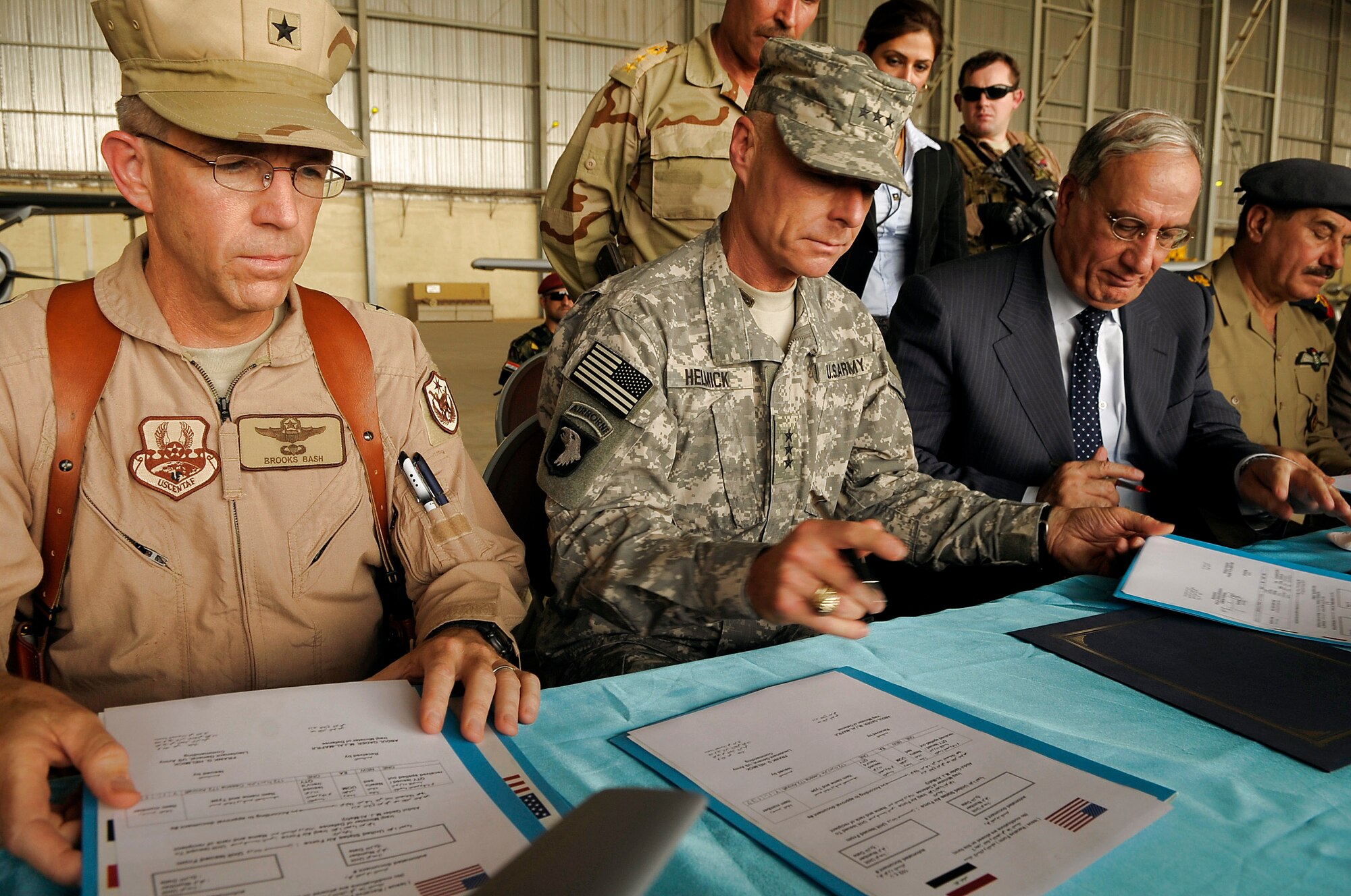 Brig. Gen. Brooks L. Bash, Coalition Air Force Training Team commander,  Army Lt. Gen. Frank Helmick, commander of Multi-National Security Transition Command-Iraq, Iraqi Defense Minister Abdul-Qader Mohammed Jassim, and Iraqi Air Force Chief Kamal Abdul-Sattar al-Barazanchi sign paperwork to transfer ownership of 11 U.S. Forces aircraft to the Iraqi air force at New Al Muthana Air Base, Iraq, July 9. General Helmick signed over eight Cessna 172s and three Cessna Caravan 208s worth more than $9 million to the Iraqi Defense Minister. (U.S. Air Force photo/Tech. Sgt. Jeffrey Allen)