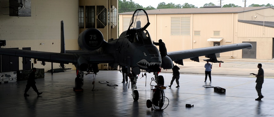 MOODY AIR FORCE BASE, Ga. -- Members of the 23rd Aircraft Maintenance Squadron perform required procedures during a load-crew competition here July 11. The quarterly competition consists of two three-man teams competing for the title of best load crew in the wing. (U.S. Air Force photo by Airman 1st Class Brittany Barker)