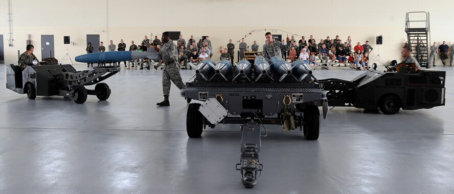 MOODY AIR FORCE BASE, Ga. -- Members of he 74th and 75th Aircraft Maintenance Squadrons lift BDU-50 bombs with lift trucks to install them onto A-10C Thunderbolt II aircraft during a load crew competition here July 11. The two competing three-man crews loaded seven bombs and two missiles each in a head-to-head time-trial. (U.S. Air Force photo by Airman 1st Class Brittany Barker)