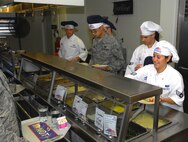 MINOT AIR FORCE BASE, N.D. -- Food service Airmen with the 5th Force Support Squadron here take joy in serving food to their fellow Airmen recently at the Dakota Inn Dining Facility. (U.S. Air Force photo by Airman 1st Class Benjamin Stratton)