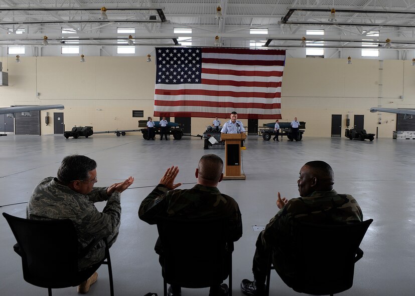 MOODY AIR FORCE BASE, Ga. -- Col. Bryan Glynn, 23rd Maintenance Group commander, Chief Master Sgt. Ronald Mcatee, 23rd MXG superintendent, and Chief Master Sgt. Kenneth Lilly, 23rd Wing Weapons Manager, clap as the names of the crew members participating in the load crew competition are announced here July 11. The competition consisted of two three-man teams competing for the win. (U.S. Air Force photo by Airman 1st Class Brittany Barker)