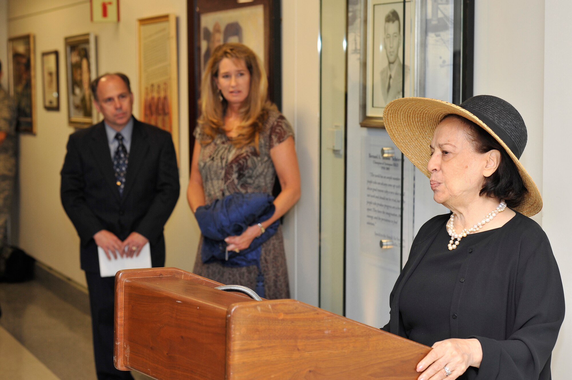 Joni James, widow of Gen. Bernard Schriever, speaks at a ceremony for the unveiling of a portrait of her late husband July 8 at the Pentagon. The portrait, a pencil drawing by Air Force visual information specialist Thomas Segars, left, will hang permanently as a memorial to General Schriever. Lori Dawson, center, also an Air Force visual information specialist, designed the display in which the portrait hangs.  (U.S. Air Force photo/Scott M. Ash) 