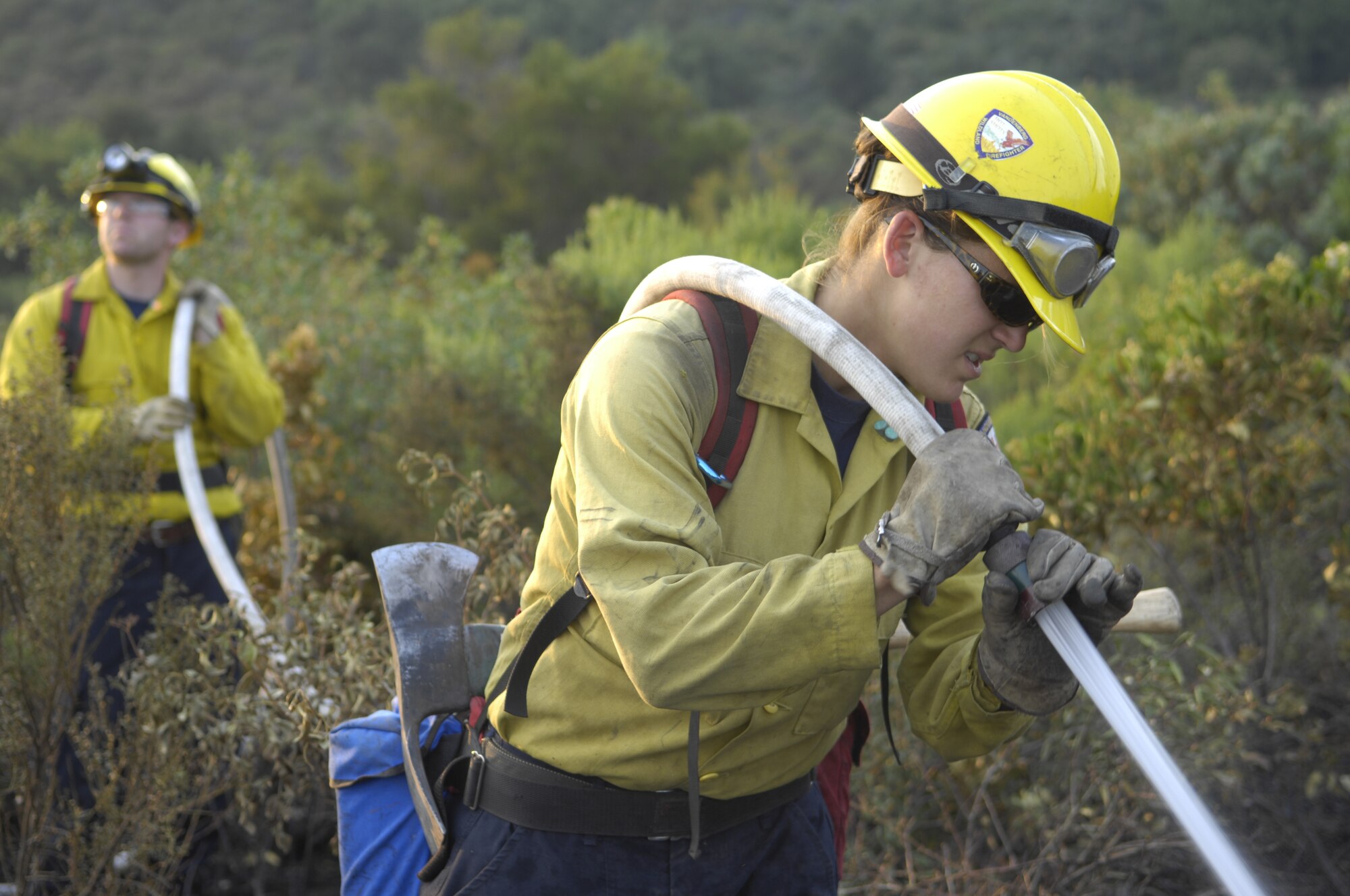 SANTA BARBARA, Calif. -- Marissa Halbeisen, a firefighter with The 30th Civil Engineering Squadron at Vandenberg Air Force Base, sprays the ground with fire retardant, to prevent it from reigniting.  Vandenberg firefighters support the local community by helping fight the Santa Barbara wildland fires.  (U.S. Air Force photo/Airman 1st Class Andrew Lee)