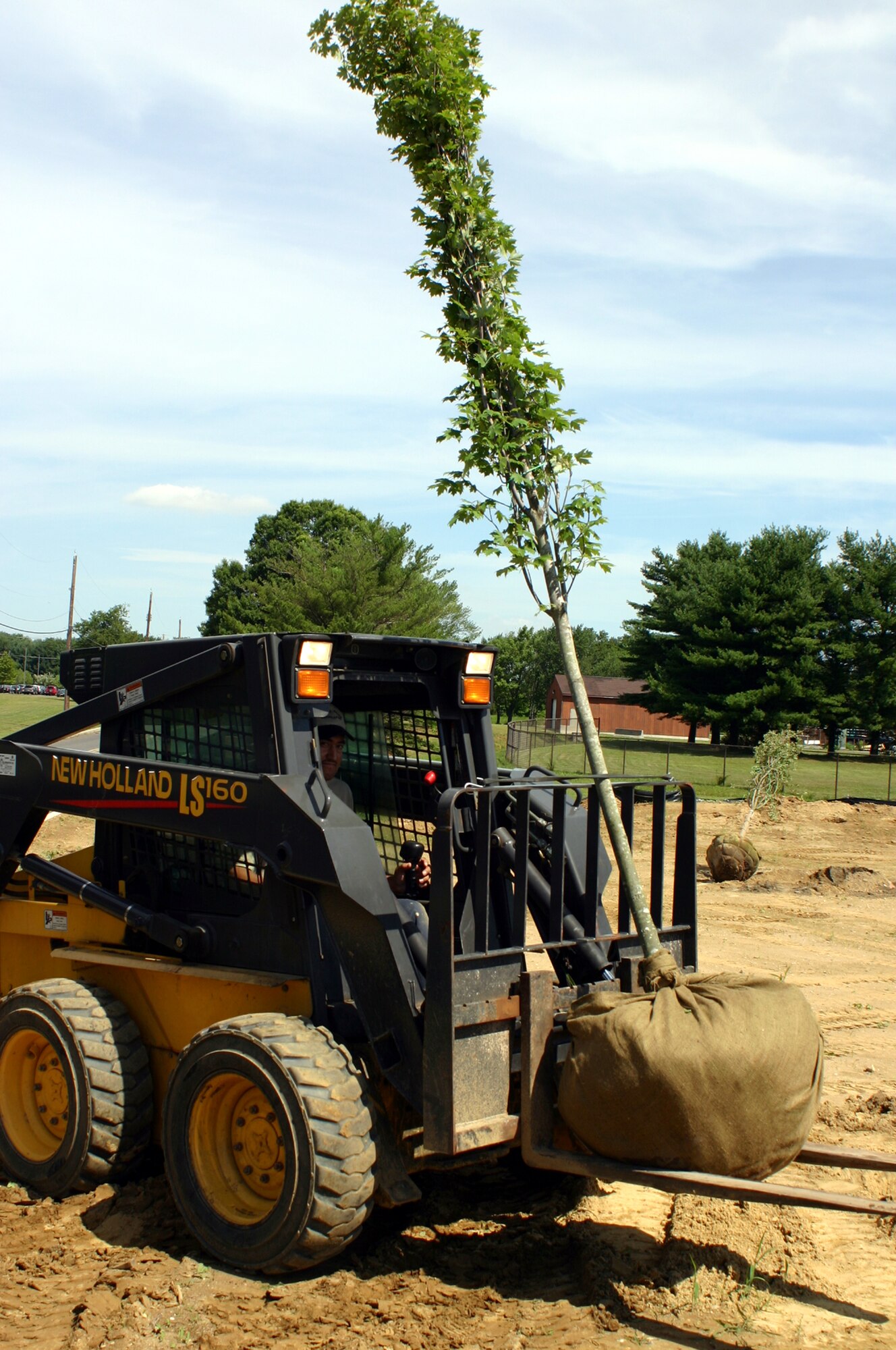 Workers help deliver trees to Starlifter Memorial Park June 10 here. The park, currently under construction, is scheduled to receive benches, a monument memorializing those who flew the C-141 Starlifter, and a walkway around the aircraft with dedication stones from those who contributed to the project. The Tommy B. McGuire Foundation, along with United Communities, is coordinating the construction efforts. (U.S. Air Force photo/Airman 1st Class Bekah Phy)