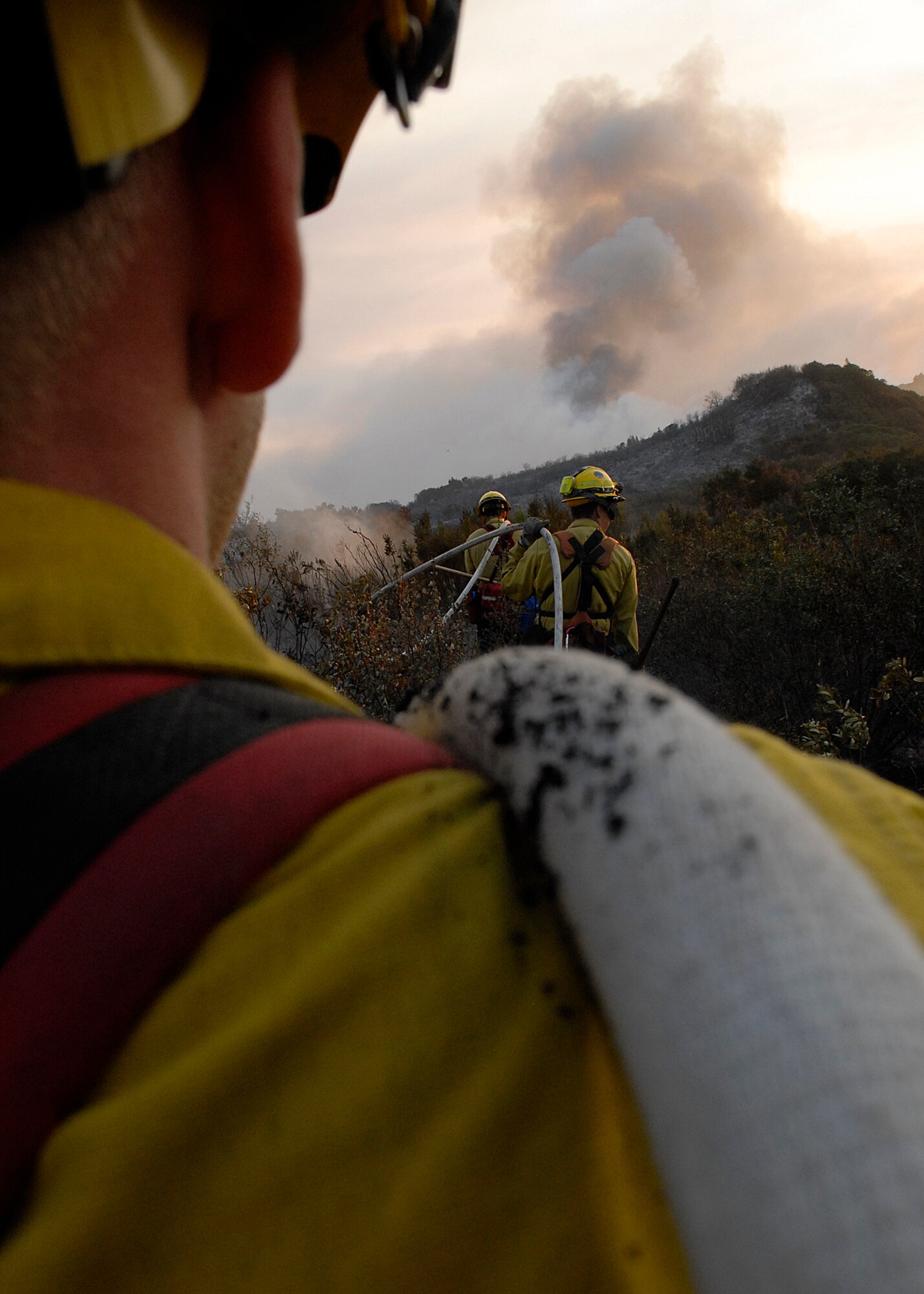 SANTA BARBARA, Calif. -- Staff Sgts. Jeremy Camacho and James Betts, and Marissa Halbeisen, firefighters with the 30th Civil Engineer Squadron at Vandenberg Air Force Base, help  extinguish a small brush fire. Team V firefighters are the only firefighters in the Air Force trained for wildland fires.  (U.S. Air Force photo/Airman 1st Class Andrew Satran)
