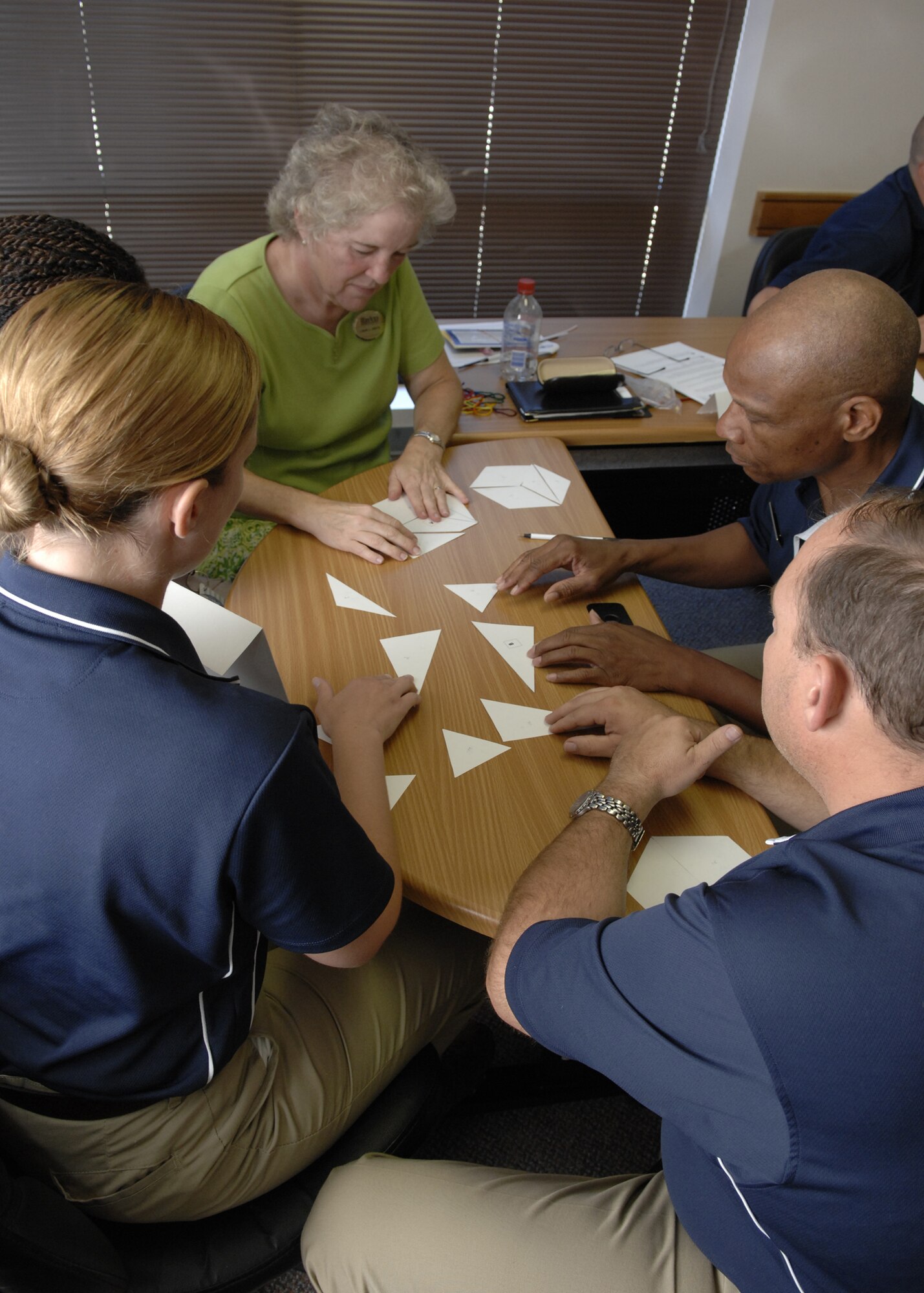 Team Holloman members participate in a silent team activity by using only body language as part of the Customer College Course, July 2 at the Holloman's Customer College and Training Center at Holloman Air Force Base, N.M. (U.S. Air Force photo/Airman 1st Class Rachel A. Kocin)