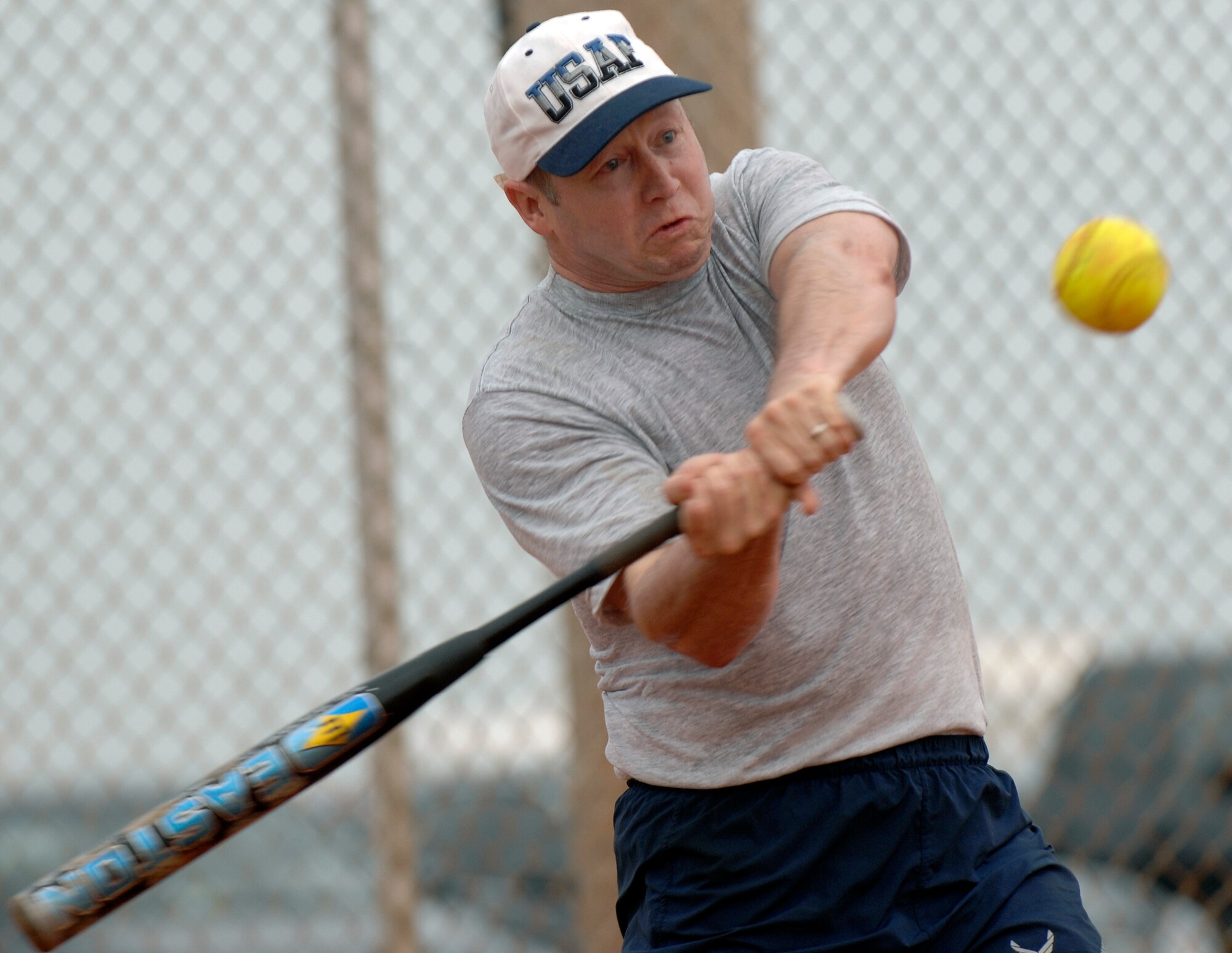 LANGLEY AIR FORCE BASE, Va, -- Col. Joe Simpson, Air Combat Command, swings at a ball during a Chiefs vs. Colonels softball game July 10. Langley chiefs and colonels get together annually to play softball. Colonel Simpson's hits helped lead the colonels to win, 24-16. (U.S. Air Force photo/Senior Airman Vernon Young)