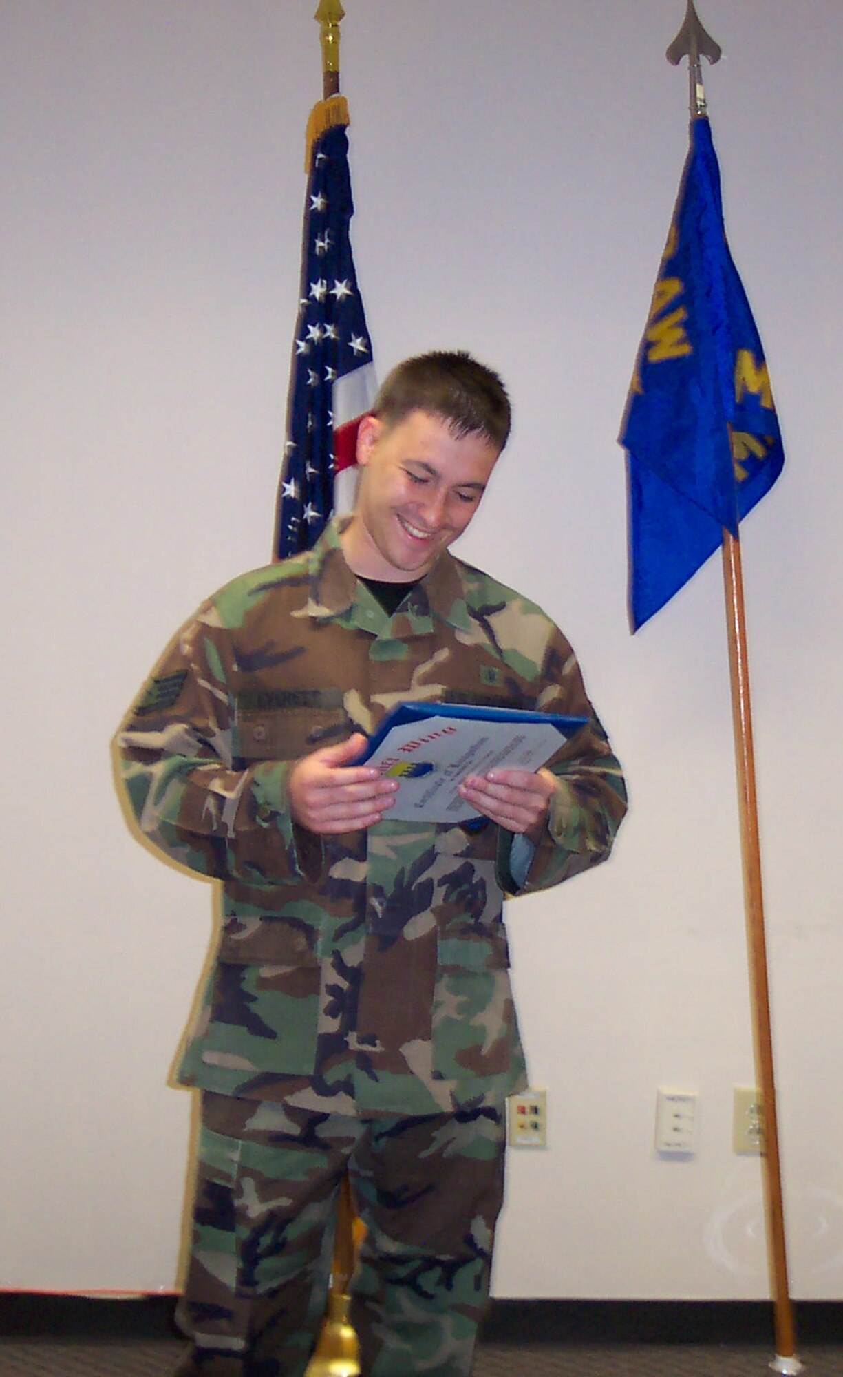Staff Sgt. Kurt Everest, 43rd Medical Operations Squadron, reads a certificate of recognition given to him at a commander’s call. (U.S. Air Force Photo)
