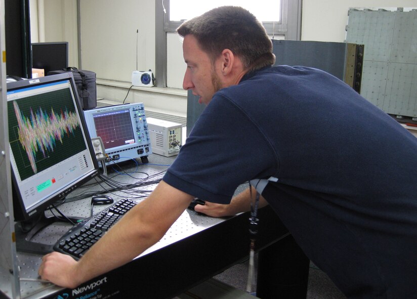 Kevin Brown, an Air Force Research Laboratory engineer at Wright-Patterson Air Force Base, analyzes signals from a piezoelectric sensor array attached to a Global Hawk test article that has been subjected to impact loads.  The sensor array, which can be used to detect structural damage, is one component of an Integrated Systems Health Management system.  (U.S. Air Force photo)