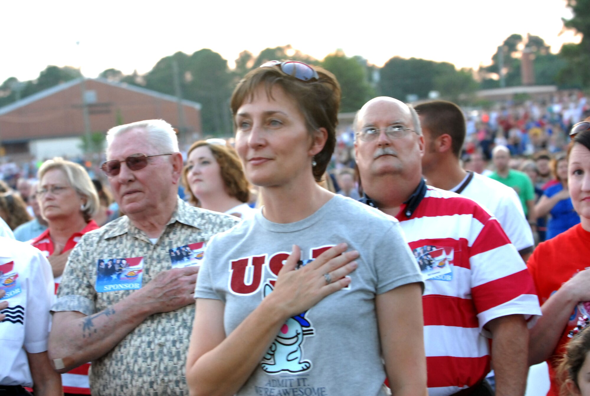 Marie Berry, wife of Warren Berry, 78th ABW commander, stands in reverence to the national anthem July 3. The Band of the U.S. Air Force Reserve teamed up with Country music group Lonestar in concert at the McConnell-Talbert Stadium for the 25th Annual Independence Day celebration. The free concert included music, fireworks and family entertainment, and was the simultaneous commemoration of America's indepence day and the 60th anniversary of the United States Air Force Reserve. U.S. Air Force photos by Ray Crayton