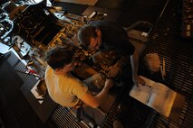 MOODY AIR FORCE BASE, Ga. -- Staff Sgt. Keith McCarthy, 23rd Equipment Maintenance Squadron crew chief, left, and SSgt Brian Peelor, 23rd Aircraft Maintenance Squadron crew chief, prepare to install a new collected booster on an HH-60G Pave Hawk here June 24. The collected booster is like power steering making it easier to control the aircraft's movement. (U.S. Air Force photo by Senior Airman Gina Chiaverotti) 