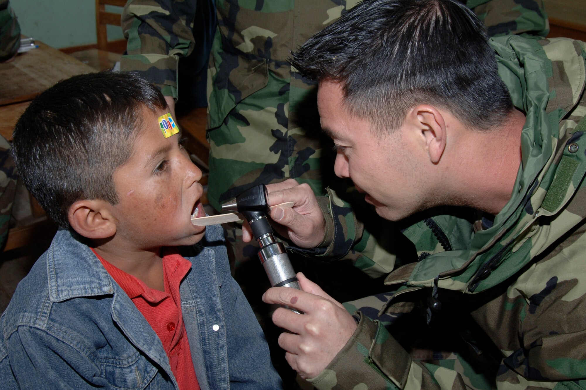 Capt. Truong Quach, a doctor from March Air Reserve Base, Calif., performs a general medical examination on a Peruvian boy, June 30, during a medical mission in Chiara, Peru.  More than 30 Air Force medical personnel deployed to Peru to support New Horizons - Peru 2008, a U.S. and Peruvian humanitarian mission that will bring quality-of-life construction and medical projects to underprivileged Peruvians. (U.S. Air Force Photo/1st Lt. Mary Pekas)