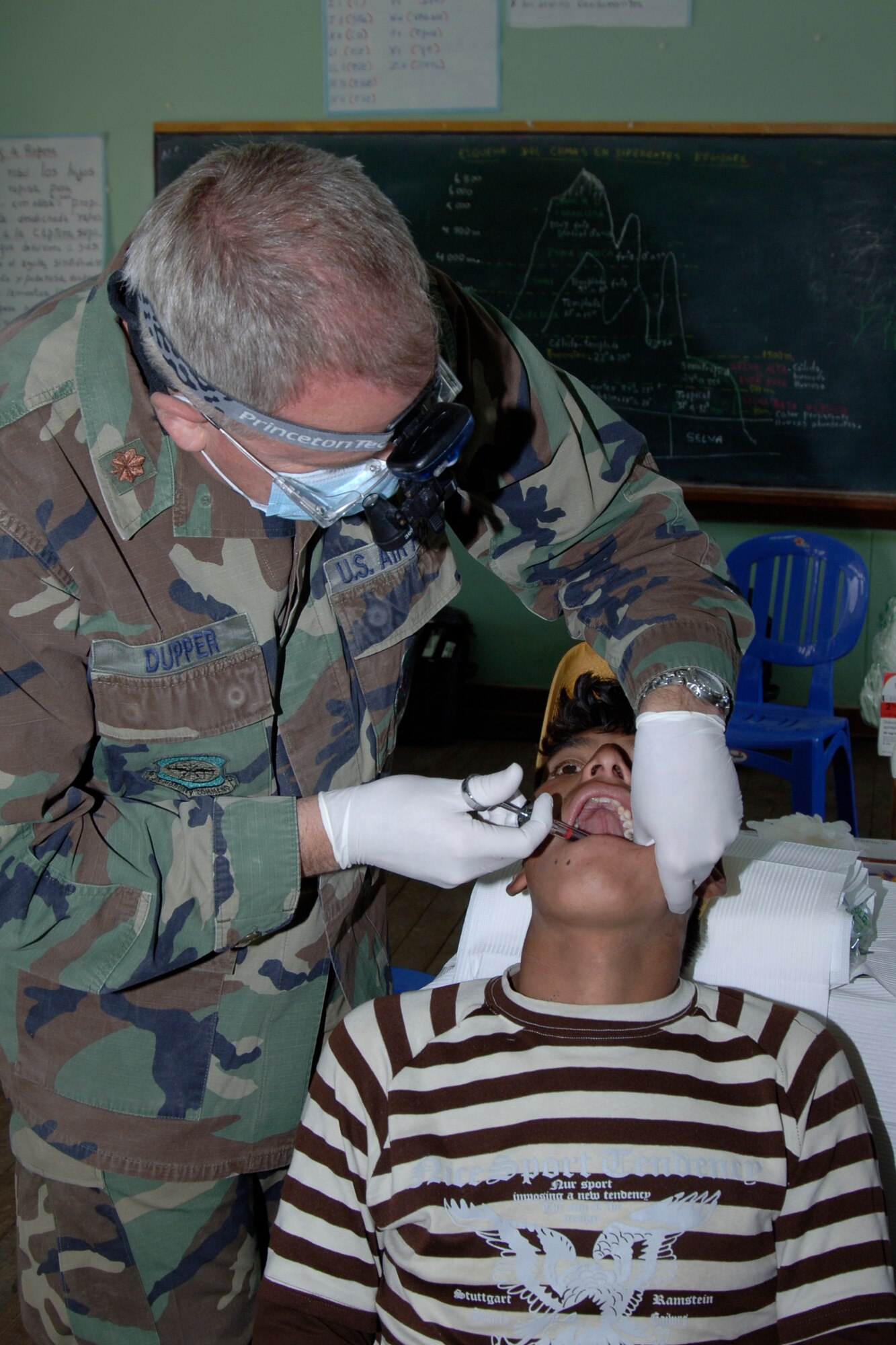 Maj. Brent Dupper, a dentist from March Air Reserve Base, Calif., performs a dental examination on a Peruvian man, June 30, during a medical mission in Chiara, Peru.  Air Force medical personnel cared for more than 4,000 Peruvians over nine days during the first set of medical missions in support of New Horizons - Peru 2008, a U.S. and Peruvian humanitarian mission that will bring relief to underprivileged Peruvians. (U.S. Air Force Photo/1st Lt. Mary Pekas)