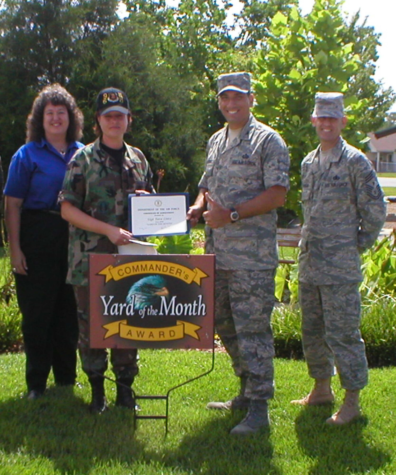EGLIN AIR FORCE BASE, Fla. -- Col. Rick LoCastro, 96th Air Base Wing vice commander, presents a certificate to  Tech Sgt. Tara Lintz for the Yard of the Month competition. Sergeant Lintz also received two $25 gift cards. Also pictured are (l-r) Sherry Harlow, Eglin Federal Credit Union and 96th ABW Command Chief Troy Engholm.  (USAF photo by Timothy Crews)  