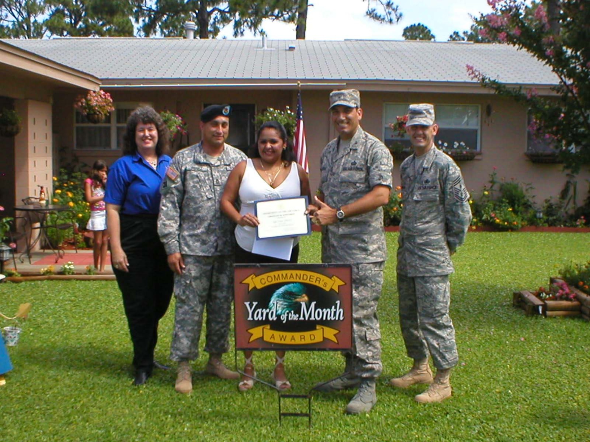 EGLIN AIR FORCE BASE, Fla. --Col. Rick LoCastro, 96th Air Base Wing vice commander, presents a certificate to  Sgt Luis Perez and wife Marilyn for the Yard of the Month competition. Sergeant Perez also received two $25 gift cards. Also pictured are (l-r)  Sherry Harlow, Eglin Federal Credit Union and 96th ABW Command Chief Troy Engholm.  (USAF photo by Timothy Crews)          
