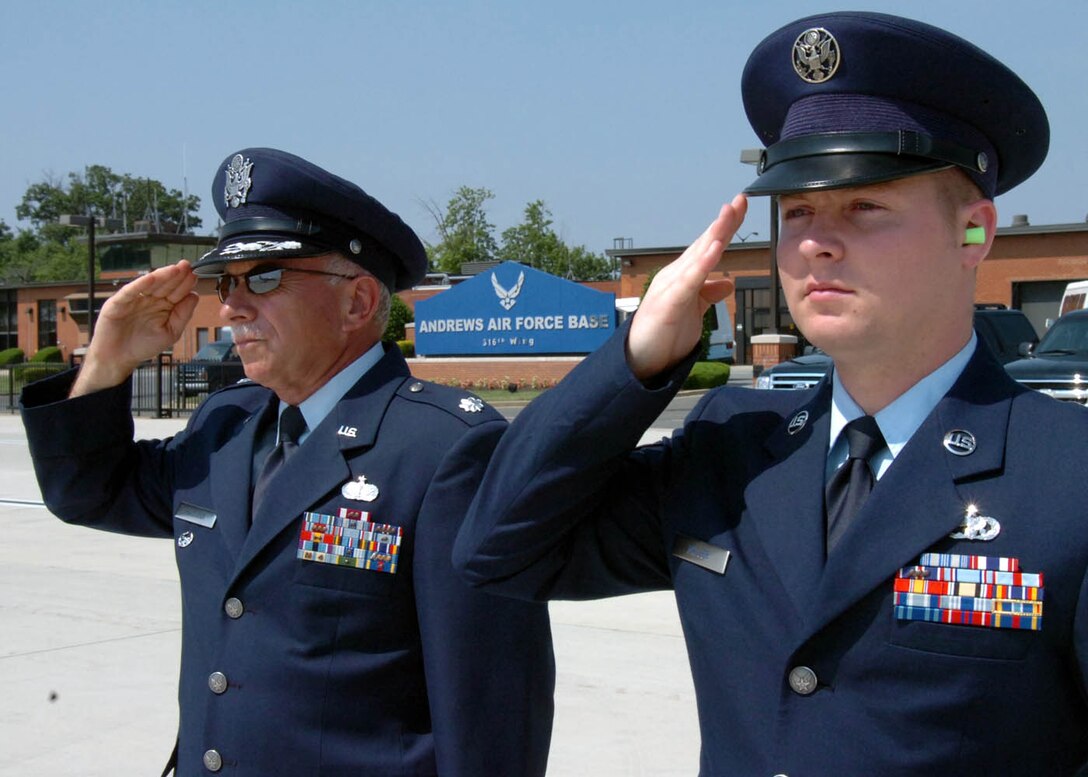 Lt. Col. Thomas Marcoux, 316th Wing Protocol senior duty officer and Staff Sgt. Christopher Miller, 89th Aerial Port Squadron Special Air Missions supervisor, salute the arrival of an inbound aircraft carrying a distinguished visitor. Protocol greets several foreign heads of state, top military officials and congressional members daily, including the President of the United States and the vice president.(US Air Force/Bobby Jones)