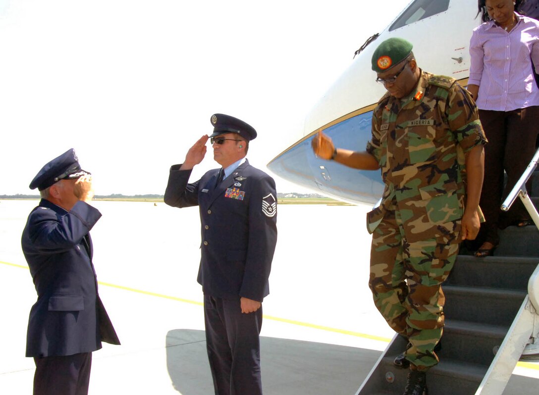 Lt. Col. Thomas Marcoux, 316th Wing Protocol senior duty officer, salutes General Owoye Andrew Azazi,  Chief of Defence Staff of the Federal Republic of Nigeria on the flightline during an official visit recently.  (US Air Force/Bobby Jones)