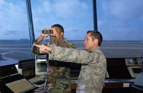 Airman 1st Class Brandon Lee, left, and Staff Sgt. Robert Butler, 37th Operations Support Squadron, monitor the Kelly Field Annex. (USAF photo by Alan Boedeker)                               