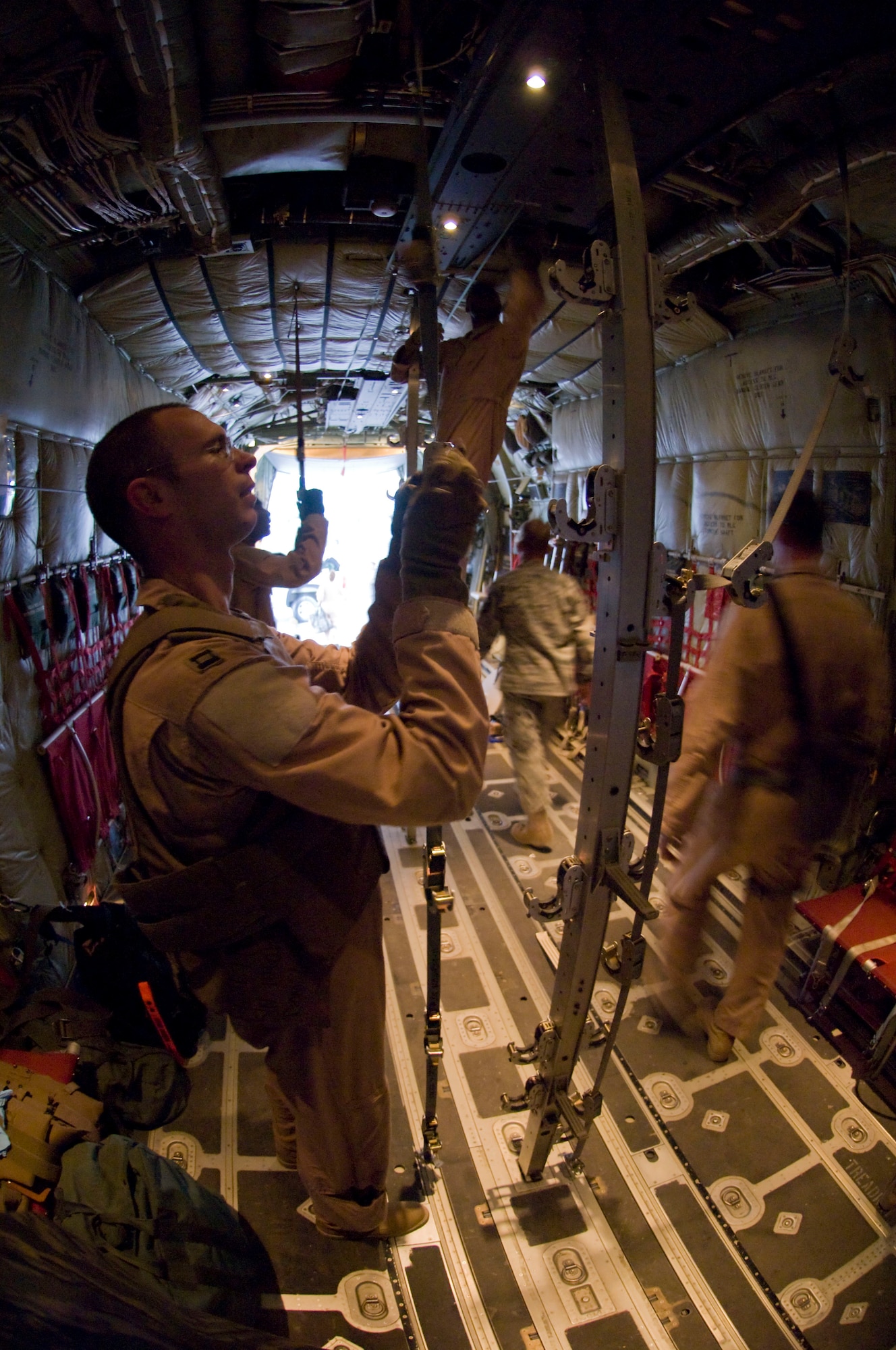 BAGRAM AIRFIELD, Afghanistan -- Members of the 455th Expeditionary Aeromedical Evacuation Flight unload a C-130 Hercules here July 8, 2008. The team facilitated the transportation of four personnel requiring medical attention to the hospital at Bagram Airfield. All five members of the team are deployed from the 375th Aeromedical Evacuation Squadron, Scott Air Force Base, Ill. (U.S. Air Force photo by Staff Sgt. Samuel Morse)
