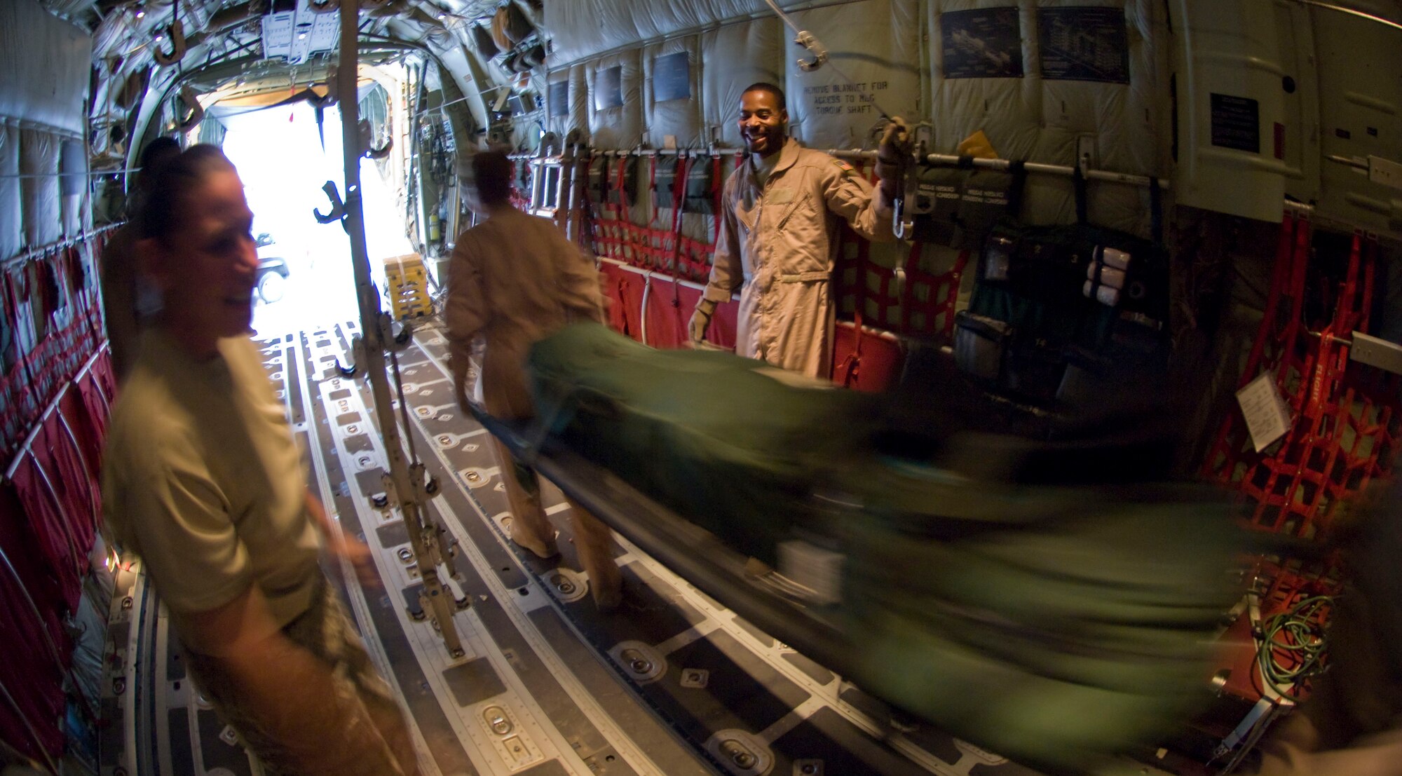 BAGRAM AIR FIELD, Afghanistan -- Members of the 455th Expeditionary Aeromedical Evacuation Flight unload an unused litter stacked with medical supplies from a C-130 Hercules here July 8, 2008. The team had converted the C-130 to be used for aeromedical evacuation and successfully transported four personnel requiring medical attention. The team is deployed from the 375th Aeromedical Evacuation Squadron, Scott Air Force Base, Ill. (U.S. Air Force photo by Staff Sgt. Samuel Morse)