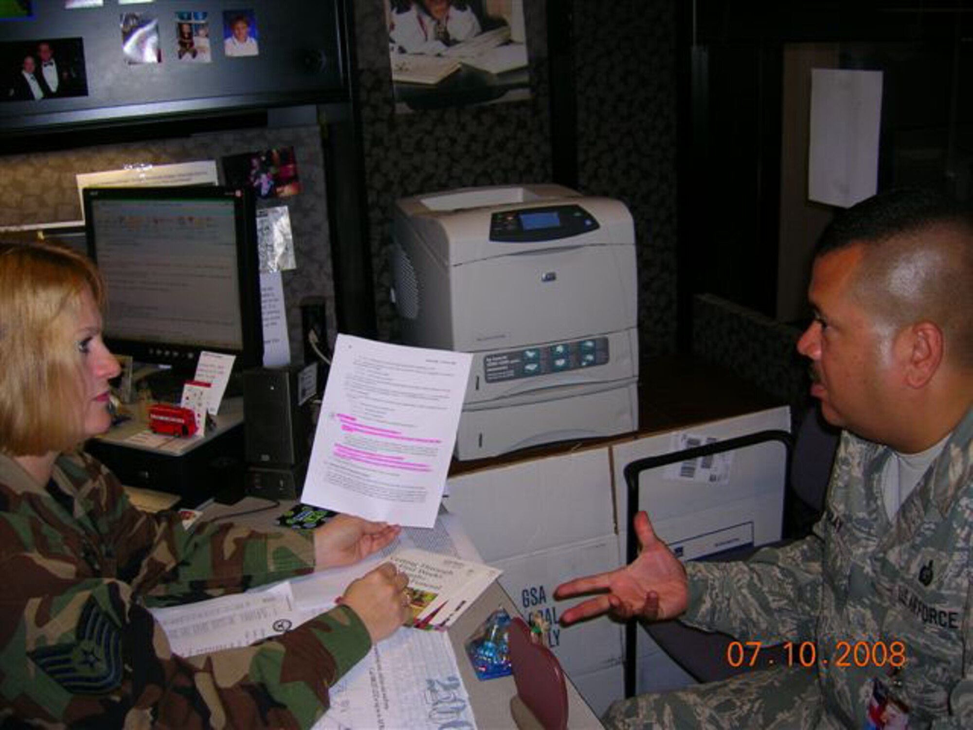 SEYMOUR JOHNSON AIR FORCE BASE, N.C. -- Tech. Sgt. Kim Browne (left) talks with her Air Force Reserve Command inspector, Chief Master Sgt. Carmelito Garay during the 916th Air Refueling Wing's Unit Compliance Inspection going on this week. Sergeant Browne is assigned to the 916th Mission Support Flight. More than 90 inspectors are at the North Carolina Reserve wing this week reviewing paperwork and processes to ensure the wing is in compliance with law and Air Force directives.
