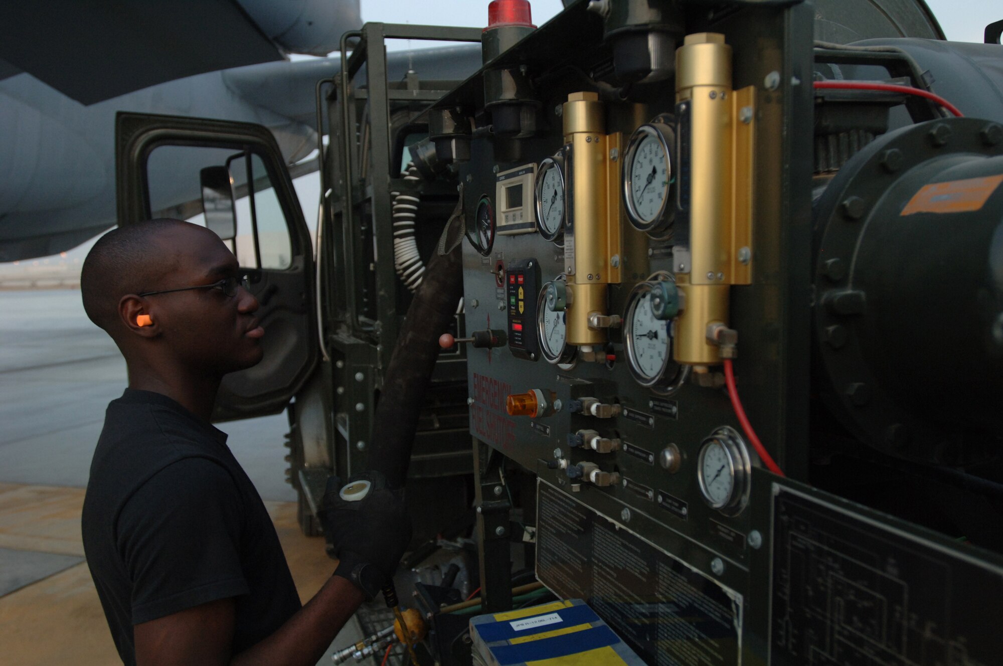 Senior Airman Jose Malonda, 380th Expeditionary Logistics Readiness Squadron Fuels Distribution Operator, refuels a KC-10 Extender recently. Airman Malonda recently set the Air Force record for most fuel pumped in one month with a total of 4,375,960 gallons issued during the month of June. (U.S. Air Force photo by Senior Airman Ross M. Tweten.)