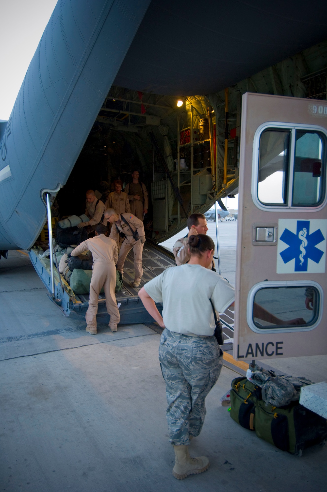 BAGRAM AIRFIELD, Afghanistan -- Members of the 455th Expeditionary Aeromedical Evacuation Flight unload a C-130 Hercules here July 8, 2008. The team facilitated the transportation of four personnel requiring medical attention to the hospital at Bagram Airfield. All five members of the team are deployed from the 375th Aeromedical Evacuation Squadron, Scott Air Force Base, Ill. (U.S. Air Force photo by Staff Sgt. Samuel Morse)