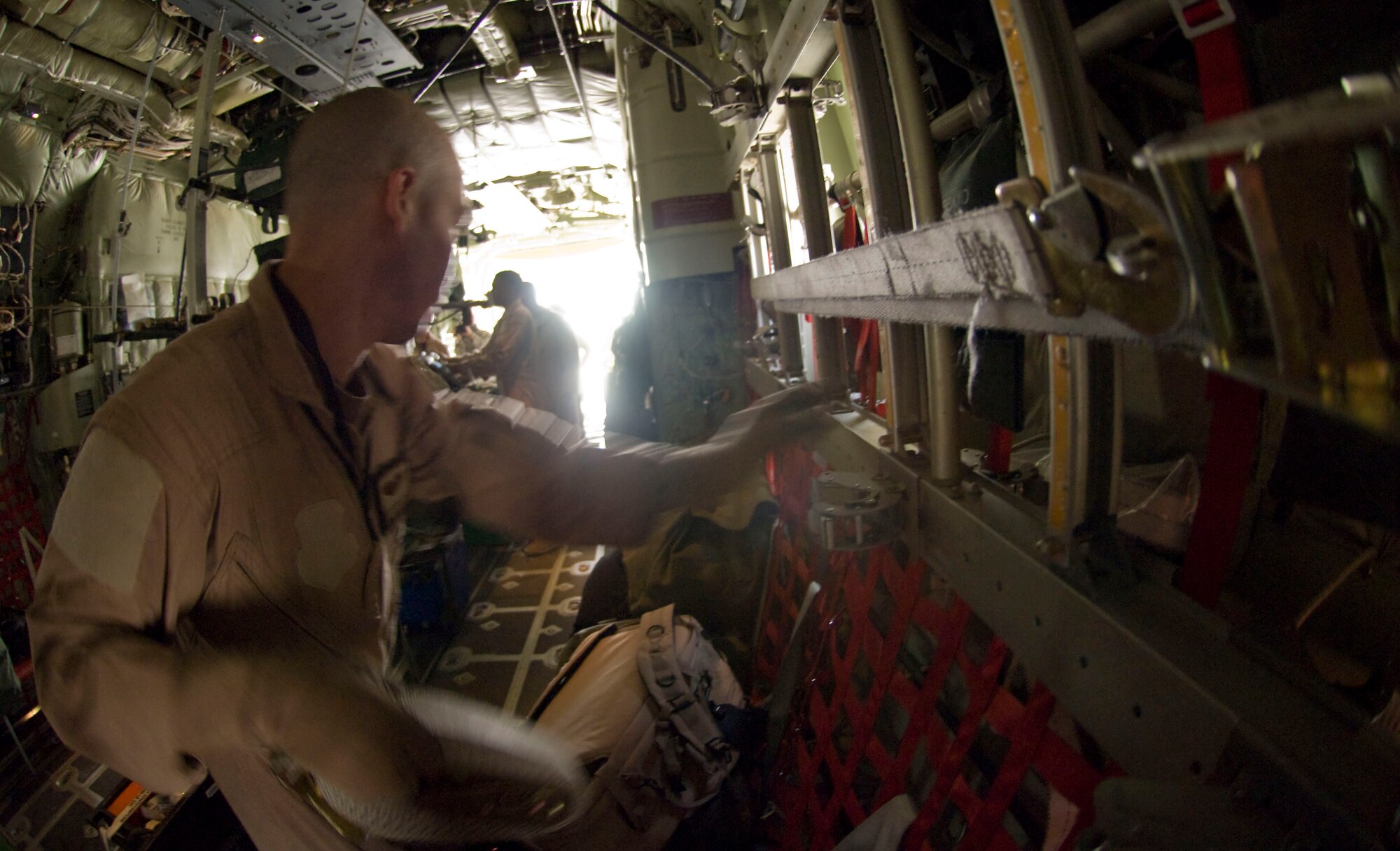 BAGRAM AIRFIELD, Afghanistan -- Staff Sgt. Victor Lopez, 455th Expeditionary Aeromedical Evacuation Flight, secures medical equipment on board a C-130 Hercules here July 8, 2008. Sergeant Lopez helped convert this C-130 to perform an aeromedical evacuation mission and is deployed from the 375th Aeromedical Evacuation Squadron, Scott Air Force Base, Ill. (U.S. Air Force photo by Staff Sgt. Samuel Morse)