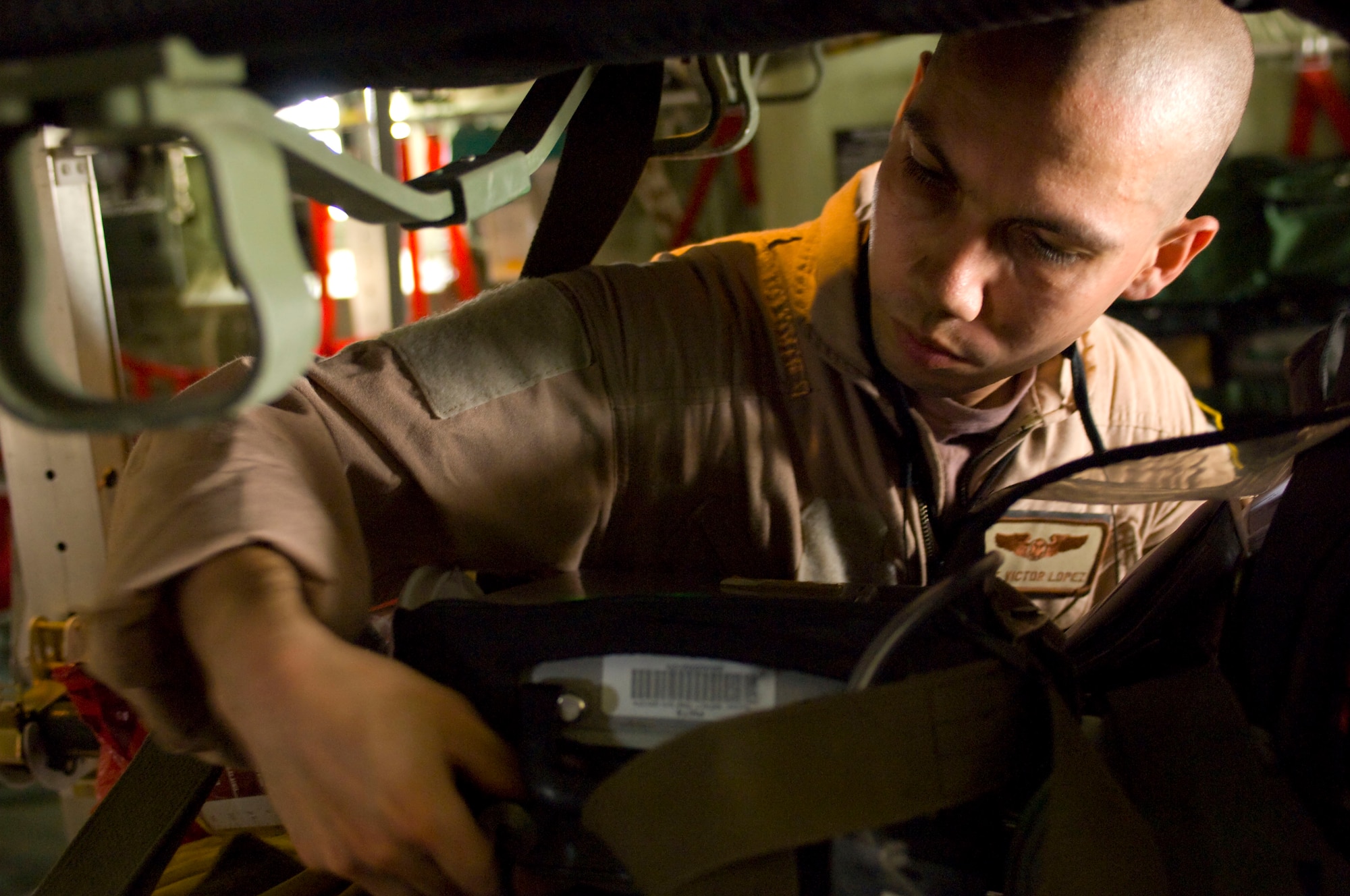 BAGRAM AIRFIELD, Afghanistan -- Staff Sgt. Victor Lopez checks the functionality of medical equipment on board a C-130 Hercules here on July 8, 2008. The function check was one step in the conversion of this C-130 for aeromedical evacuation operations. The team converting this C-130 deployed to the 455th Expeditionary Aeromedical Evacuation Flight here from the 375th Aeromedical Evacuation Squadron, Scott Air Force Base, Ill. (U.S. Air Force photo by Staff Sgt. Samuel Morse)
