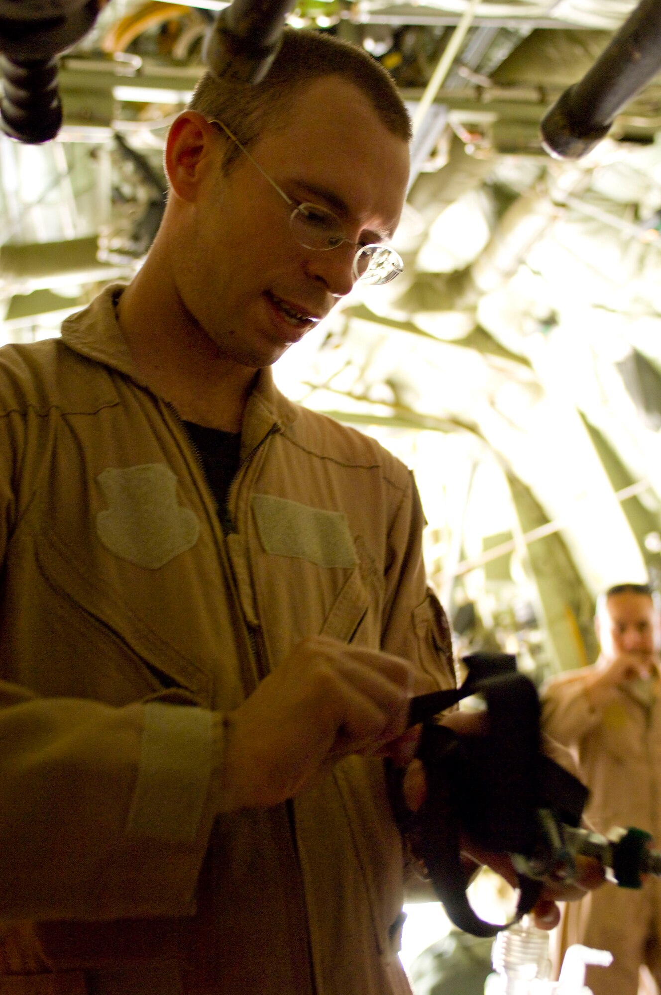 BAGRAM AIRFIELD, Afghanistan -- Capt. Matthew Rist hooks up oxygen in a C-130 Hercules here on July 8, 2008. Captain Rist, a member of the 455th Expeditionary Aeromedical Evacuation Flight, prepared the medical supplies during the C-130's conversion for an aeromedical evacuation mission. The whole team is deployed from the 375th Aeromedical Evacuation Squadron, Scott Air Force Base, Ill. (U.S. Air Force photo by Staff Sgt. Samuel Morse)