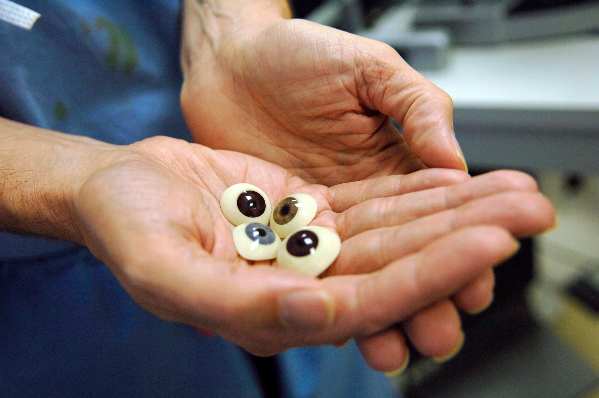 JOINT BASE BALAD, Iraq -- Col. (Dr.) Randall Beatty, 332nd Expeditionary Medical Operations Squadron ophthalmologist and orbital oculoplastics specialist, holds various prosthesis that are like large hard contact lenses that fit over the entire eye socket and give the patient a renewed sense of self. Doctor Beatty is reservist deployed from Lackland Air Force Base, Texas. (U.S. Air Force photo/Senior Airman Julianne Showalter)