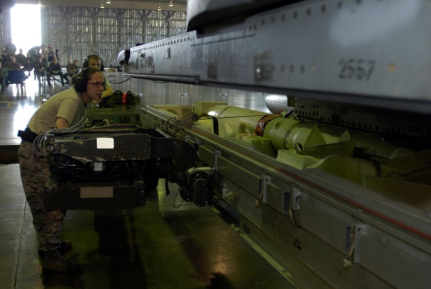 MISAWA AIR BASE, Japan -- Staff Sgt. Beverly Smith, 35th Aircraft Maintenance Squadron, makes sure everything is lined up before lowering the ammunitions case during the 2nd quarter load crew competition July 2, 2008. Sergeant Smith led her team to an outstanding finish.  (U.S. Air Force photo by Senior Airman Chad Strohmeyer)