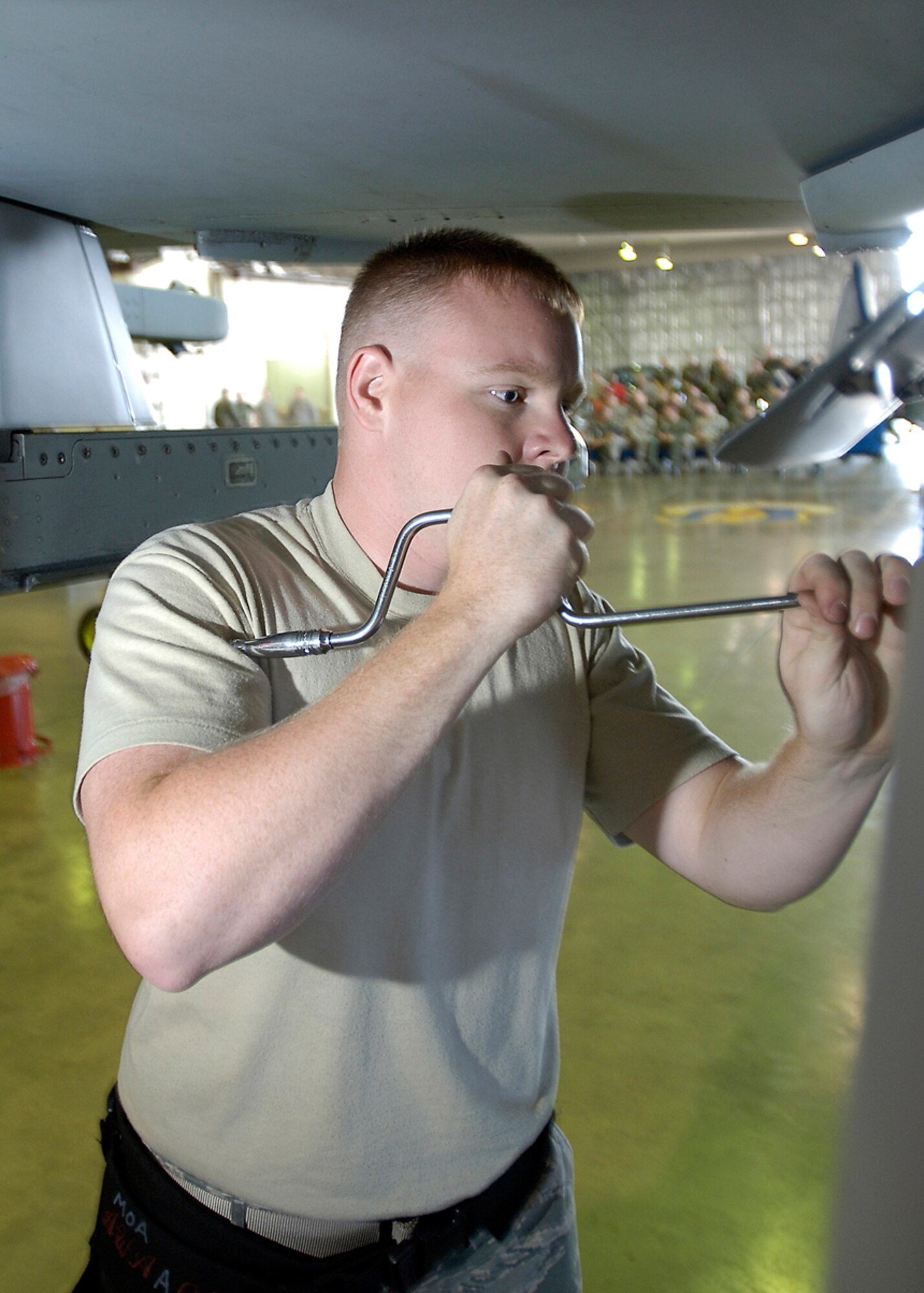 MISAWA AIR BASE, Japan -- Airman 1st Class Phillip Smith, 35th AMXS, unscrews a bolt on an F-16 Fighting Falcon during the 2nd quarter load crew competition July 2, 2008.  Airman Smith played an important role in making sure that the ammunitions were securely loaded.  (U.S. Air Force photo by Senior Airman Chad Strohmeyer)