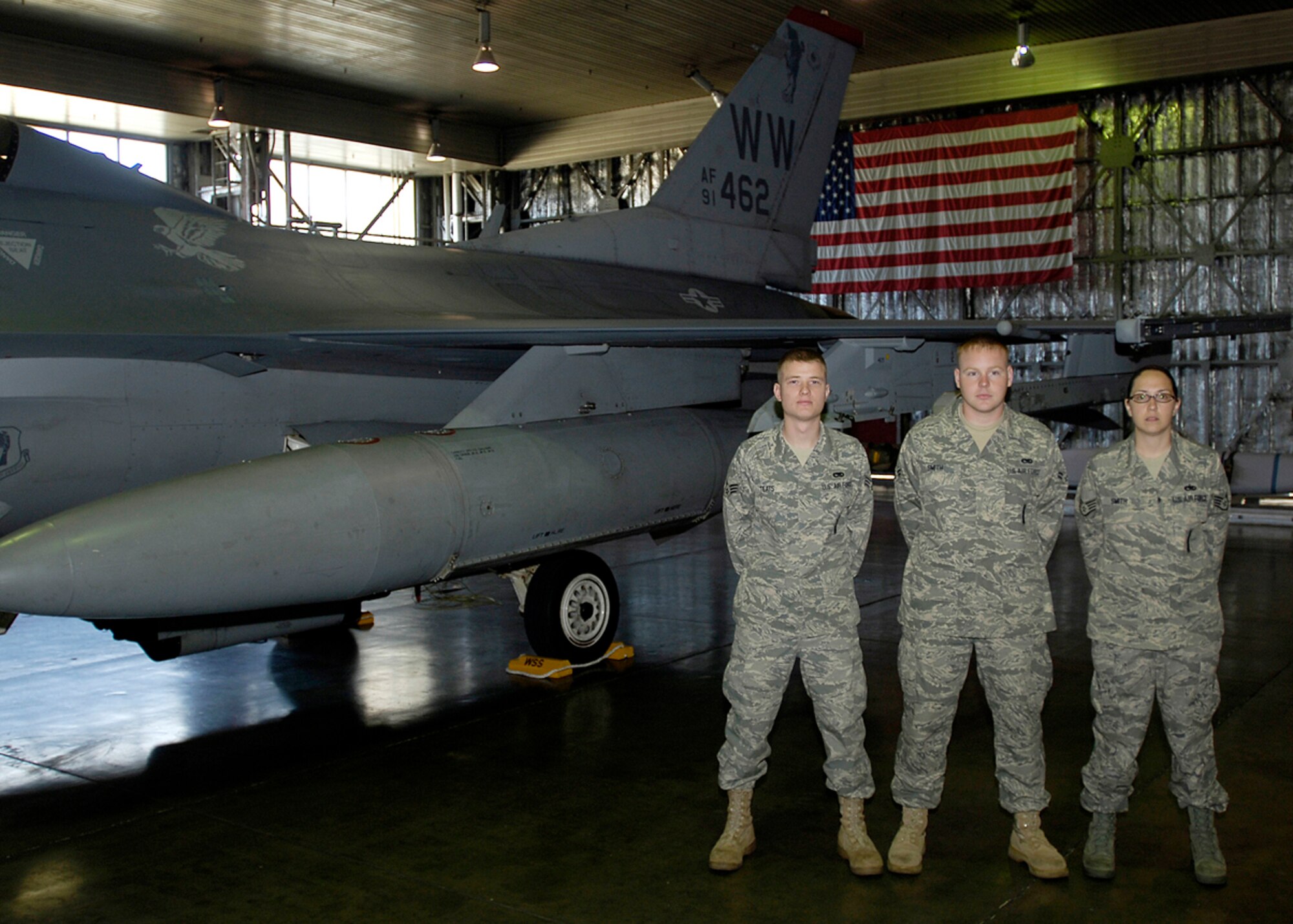 MISAWA AIR BASE, Japan -- Airman 1st Class Benjamin Teats, Airman 1st Class Phillip Smith and Staff Sgt. Beverly Smith, 35th AMXS, pose for a group photo before performing in the 2nd quarter load crew competition July 2, 2008.  Two teams of three competed in the event. (U.S. Air Force Photo by Senior Airman Chad Strohmeyer)