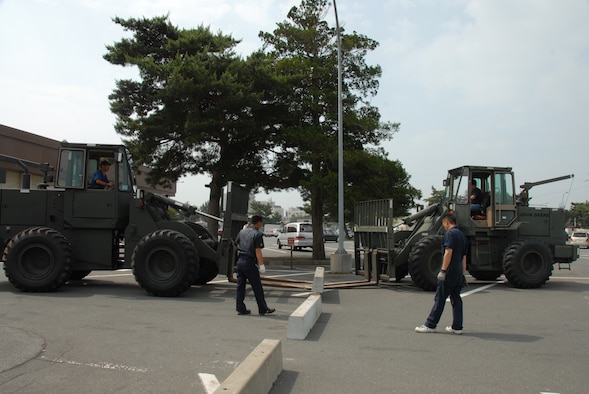 MISAWA AIR BASE, Japan -- Contractors from the 35th Logistics Readiness Squadron set up barrier engagements outside the base exchange July 7, 2008.  This measure was part of a random anti-terrorism measure during the G-8 Summit.  (U.S. Air Force photo by Senior Airman Laura McFarlane)