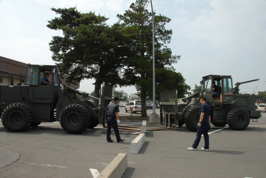 MISAWA AIR BASE, Japan -- Contractors from the 35th Logistics Readiness Squadron set up barrier engagements outside the base exchange July 7, 2008.  This measure was part of a random anti-terrorism measure during the G-8 Summit.  (U.S. Air Force photo by Senior Airman Laura McFarlane)