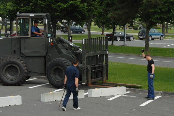 MISAWA AIR BASE, Japan -- Contractors from 35th LRS set up barrier engagements outside the base exchange July 7, 2008.  Barrier engagement are the fastest and most effience way to protect a location where mass people gather.  (U.S. Air Force photo by Senior Airman Laura McFarlane)