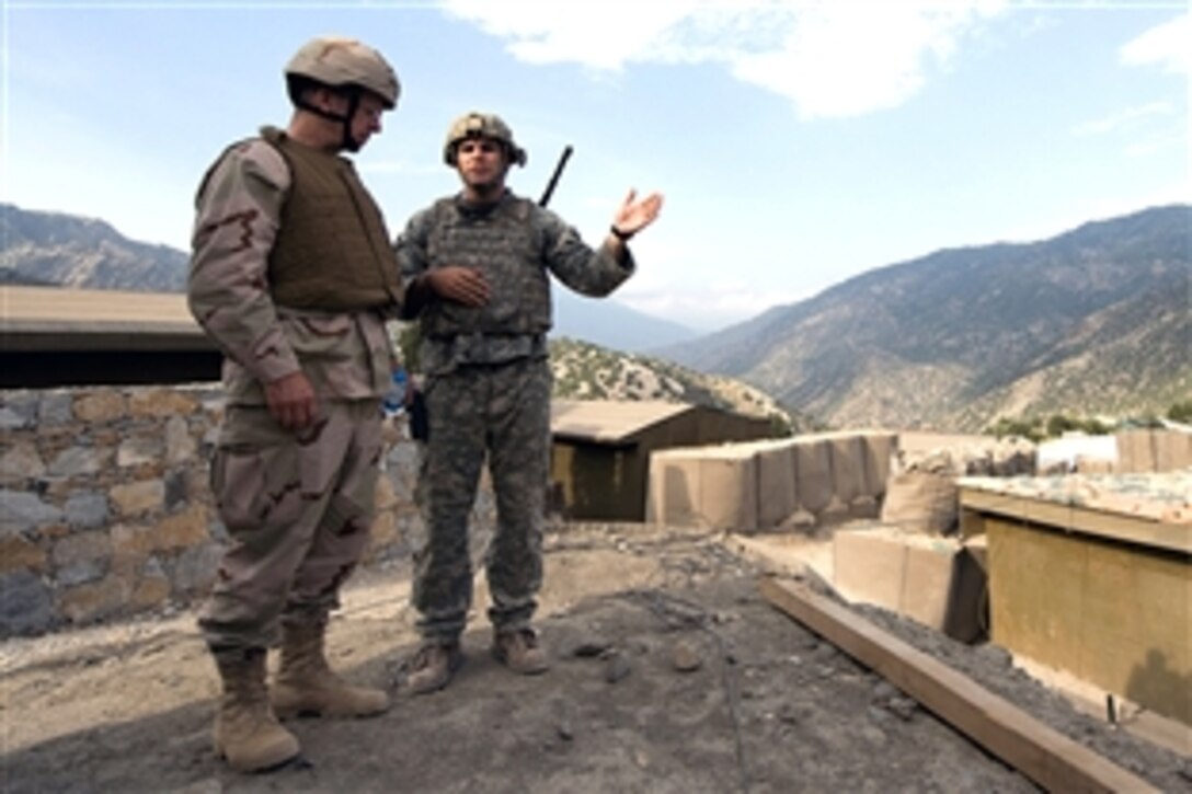 U.S. Navy Adm. Mike Mullen, left, chairman of the Joint Chiefs of Staff, receives a briefing from U.S. Army Capt. Dan Kearny on the situation at Korengal Valley, Afghanistan, July 11, 2008. Mullen conducted a six-day tour of the region to visit troops and host a visit by professional athletes through the United Service Organizations. 
