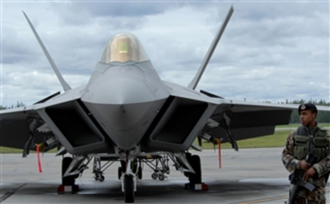 U.S. Air Force Staff Sgt. Terrance Broaddus, a member of the 354th Security Forces Squadron, guards the entry control point to an F-22A Raptor aircraft display from unauthorized entry during the "Soaring into Solstice" Thunderbirds show on June 24, 2008.  The "Soaring into Solstice" air show provided an opportunity for the local community to visit the base and get an up close view and demonstration of the capabilities of the Air Force's aircraft.  