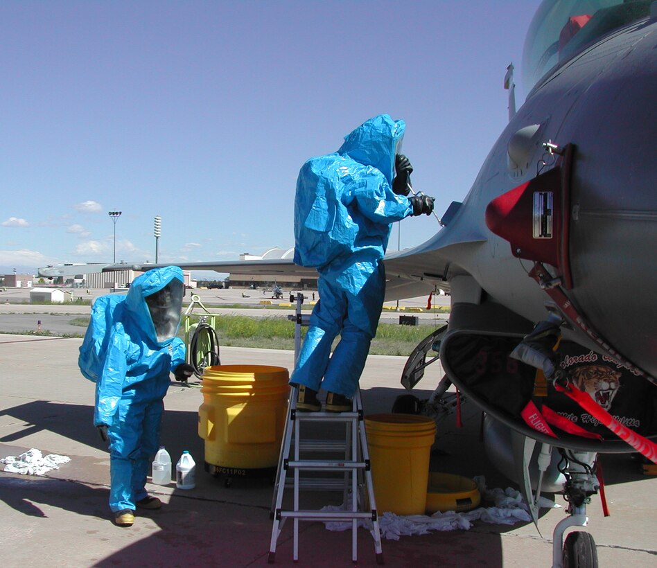 Members of the 140th Aircraft Fuels Systems Repair shop prepare to decontaminate an F-16 during a training exercise June 12.          