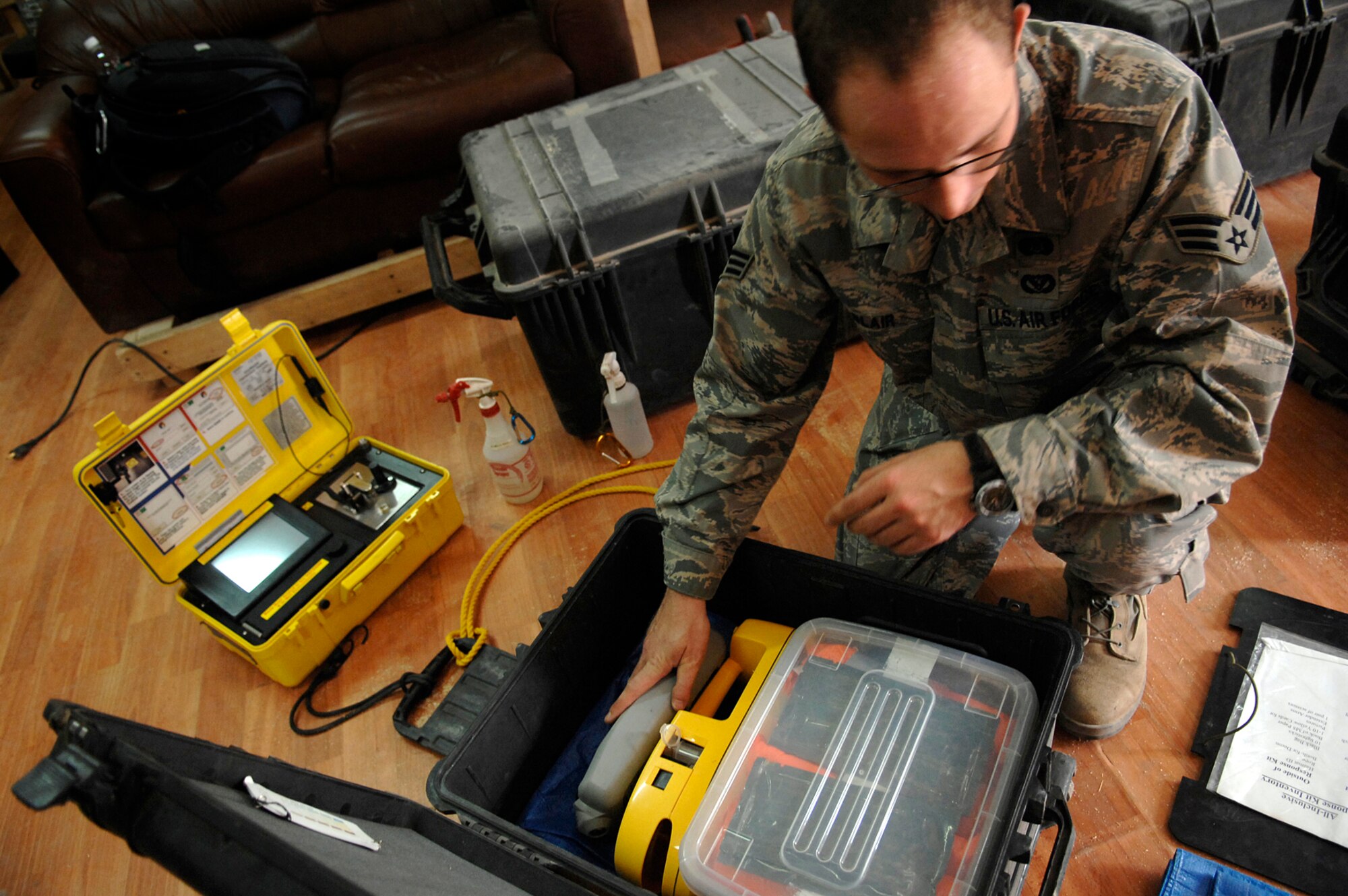 JOINT BASE BALAD, Iraq -- Senior Airman Michael Blair, 332nd Expeditionary Civil Engineer Squadron emergency management equipment technician, pieces together a 12-cubic-foot box used to hold instruments needed for responding to hazardous material situations here July 12. The kit replaces a previous four-case response package. Using one response kit instead of three or four has cut the 332nd ECES' Emergency Management Flight's response time by more than 75 percent. Airman Blair is deployed from McGuire Air Force Base, N.J. (U.S. Air Force photo/ Senior Airman Julianne Showalter)